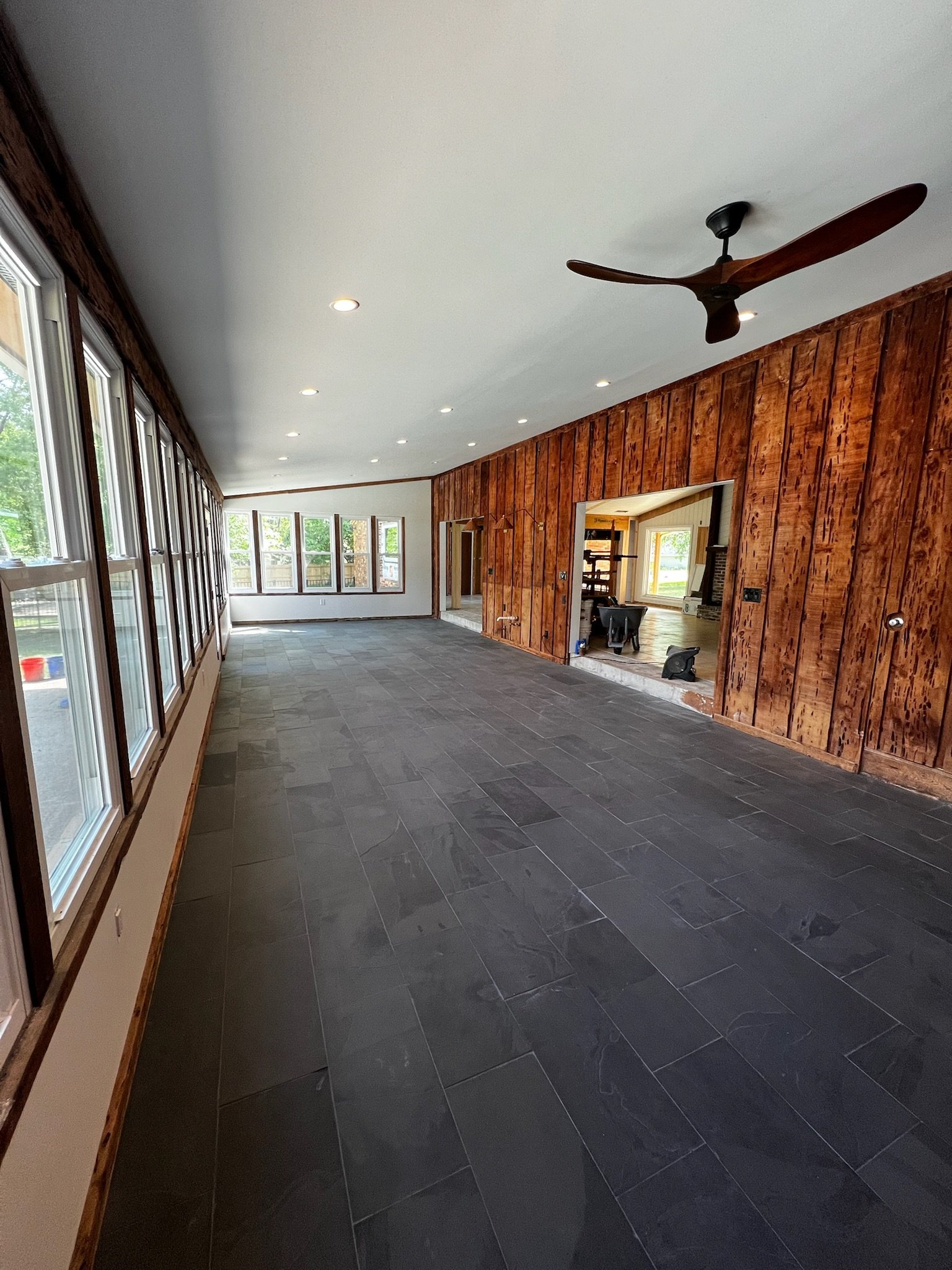 During- Slate flooring install, new lighting, switches and receptacles, new drywall surrounding windows, new sheetrock on ceiling, all smooth textured walls/ceiling and new paint.