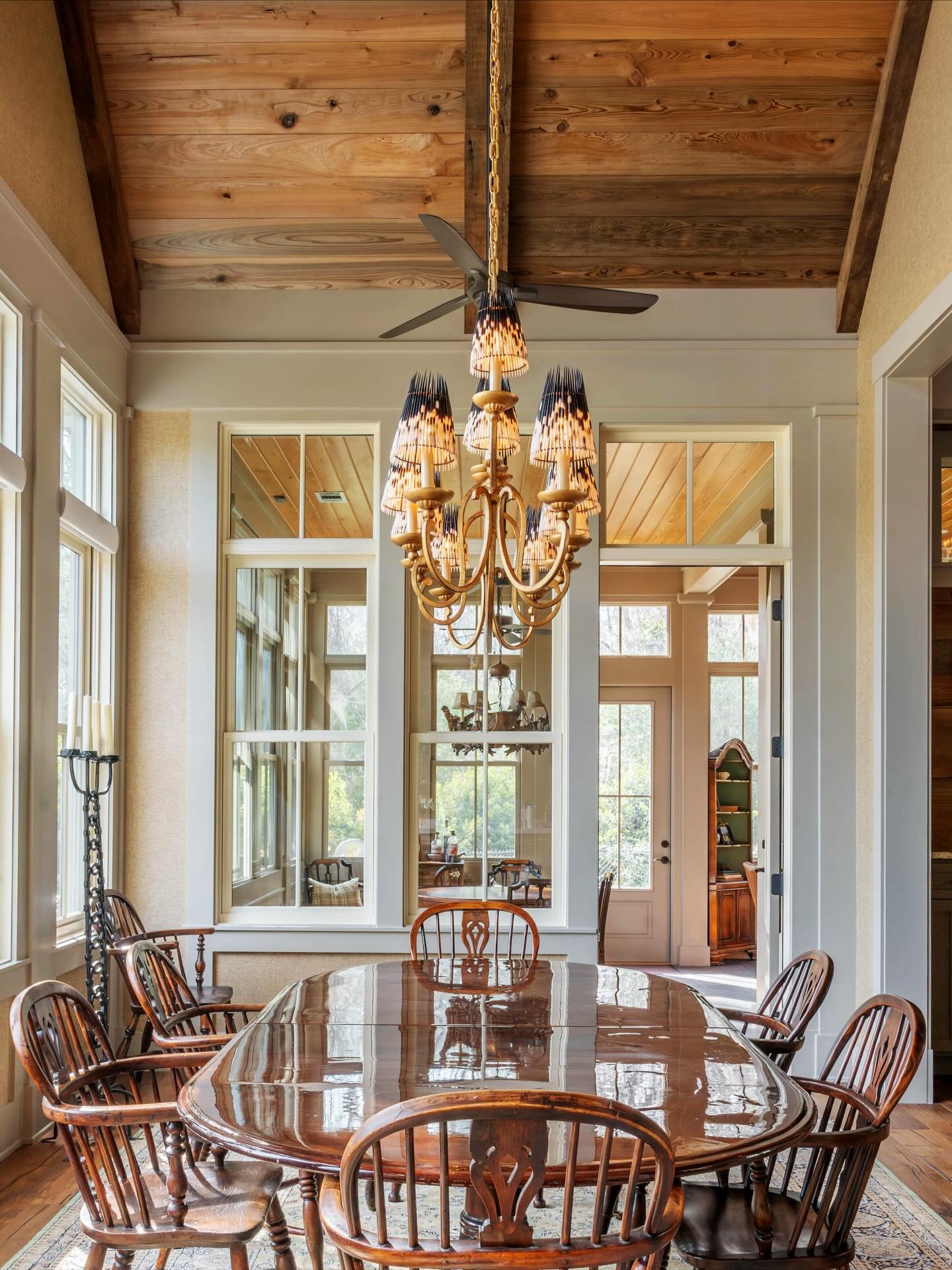 New heights. This dining room had amazing natural light and vaulted ceilings, but it lacked warmth. Sinker cypress ceilings and grasscloth wallcovering created an inviting atmosphere, while the custom porcupine lamp shades on the @visualcomfort chand