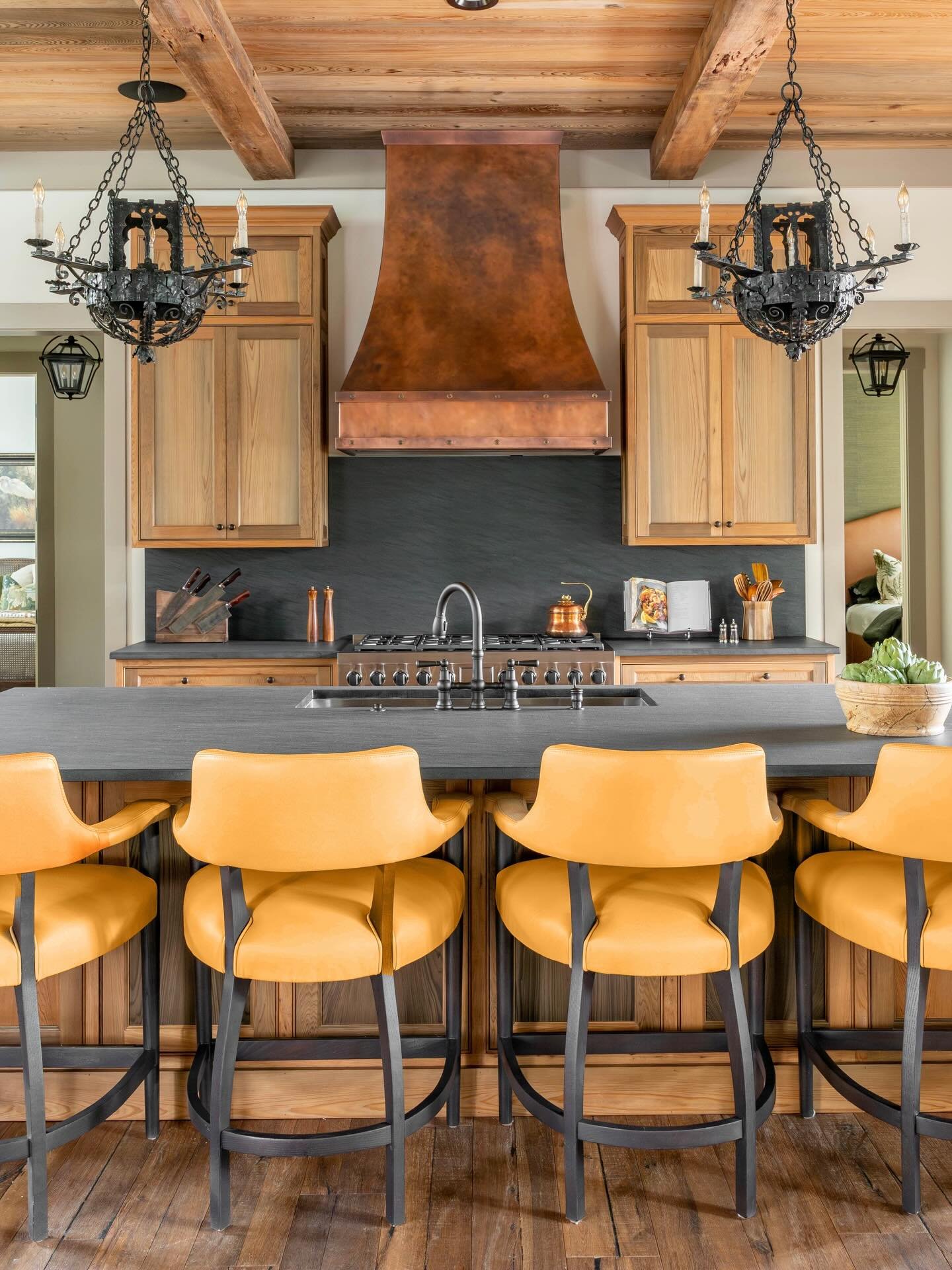 Well balanced. These custom sinker cypress cabinets by @perrin_woodworking remain a favorite of mine. We paired them with a leathered granite from @agmimports, antique italian iron chandeliers from @1stdibs and incredibly comfortable leather counter 