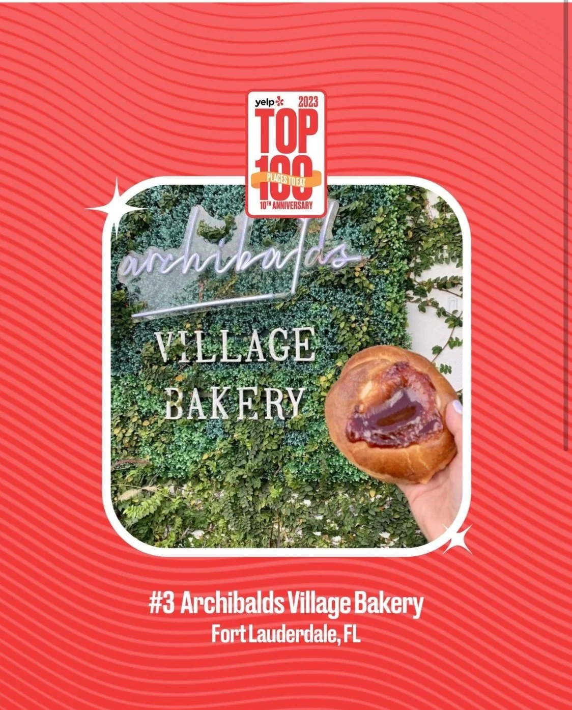 Photo of a hand holding a pastry with jam filling in front of a green leafy wall with a neon sign that says 'arhbalds' and a sign that says 'VILLAGE BAKERY'. The image has a red background with an award badge at the top.