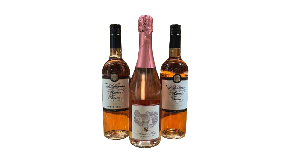 Three bottles of rosé wine, with the middle one having a pink foil top, and the other two labeled 'Bohemia Manor Farm'.