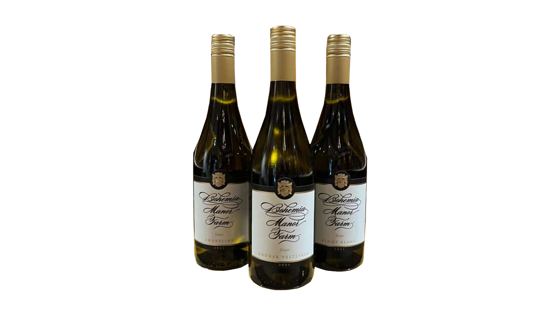 Three bottles of Bohemia Manor Farm white wine, Pinot Blanc wine with gold-colored screw caps and white labels, arranged in a row on a black background.