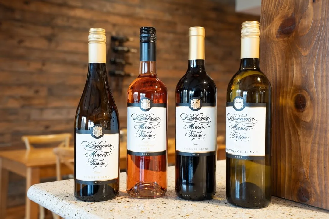 A bottle of Bohemia Mano Posmo Cabernet Franc wine on a kitchen countertop next to a decorative pumpkin.