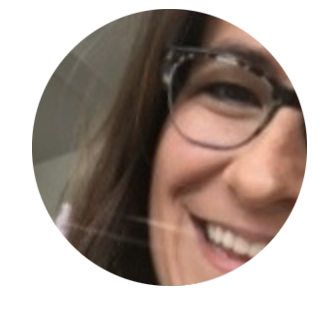Close-up of a smiling Kelly Ardoin wearing glasses.