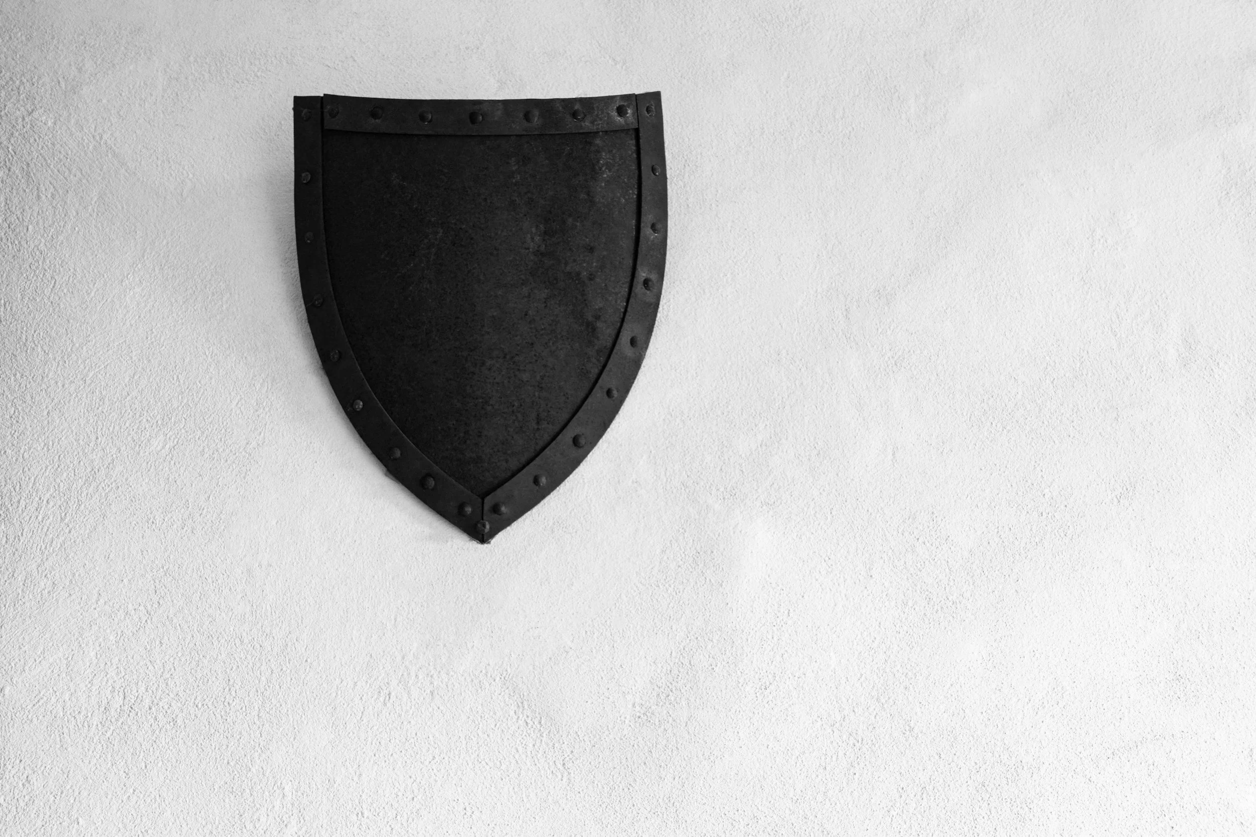 Snow-capped mountains with a modern building on grassy hills