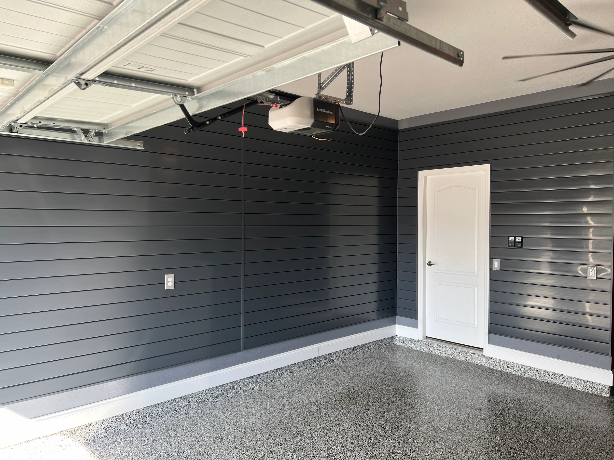 Garage walls covered in charcoal gray slatwalls