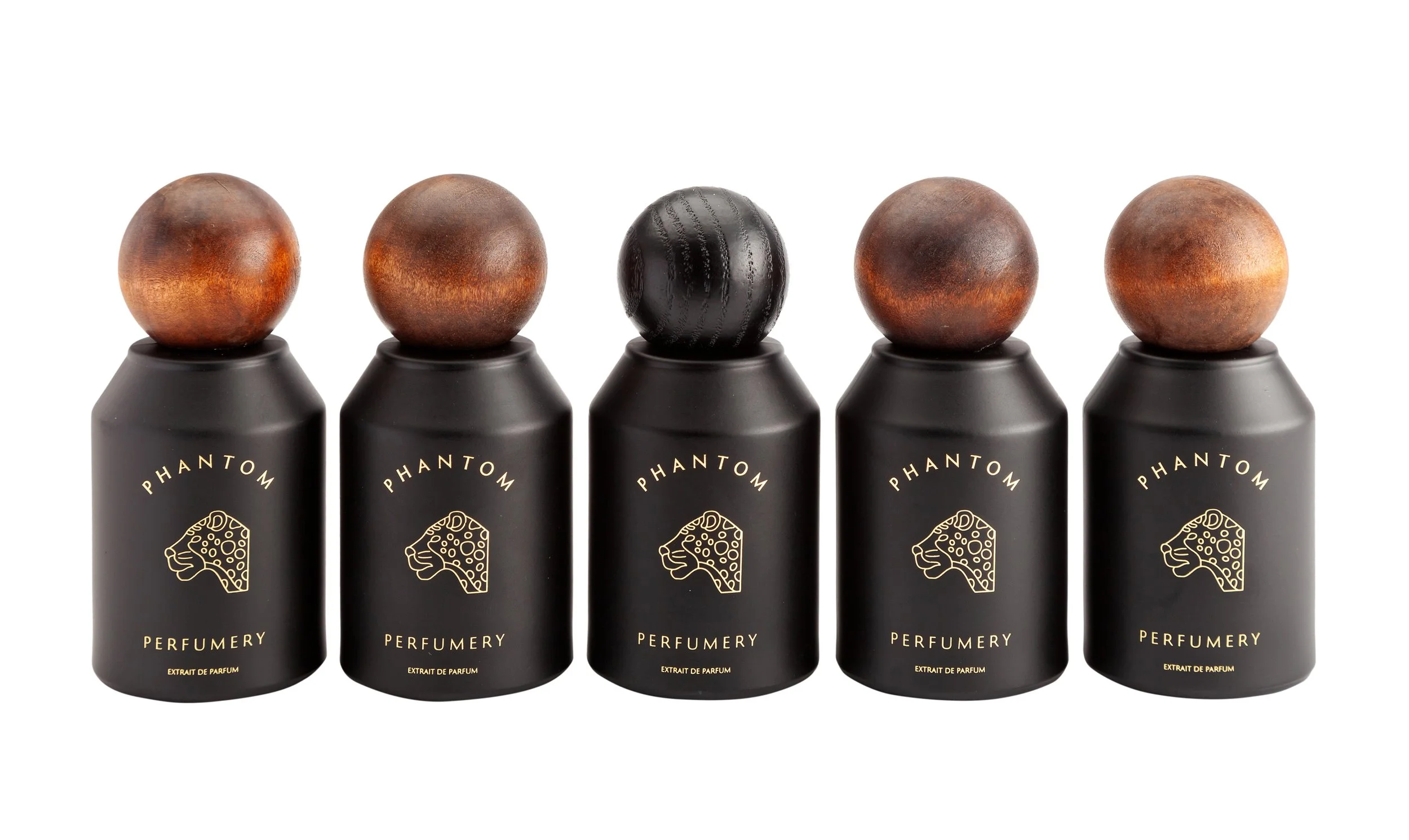 Five black bottles of Phantoms Perfume with wooden caps in a row, against a white background.