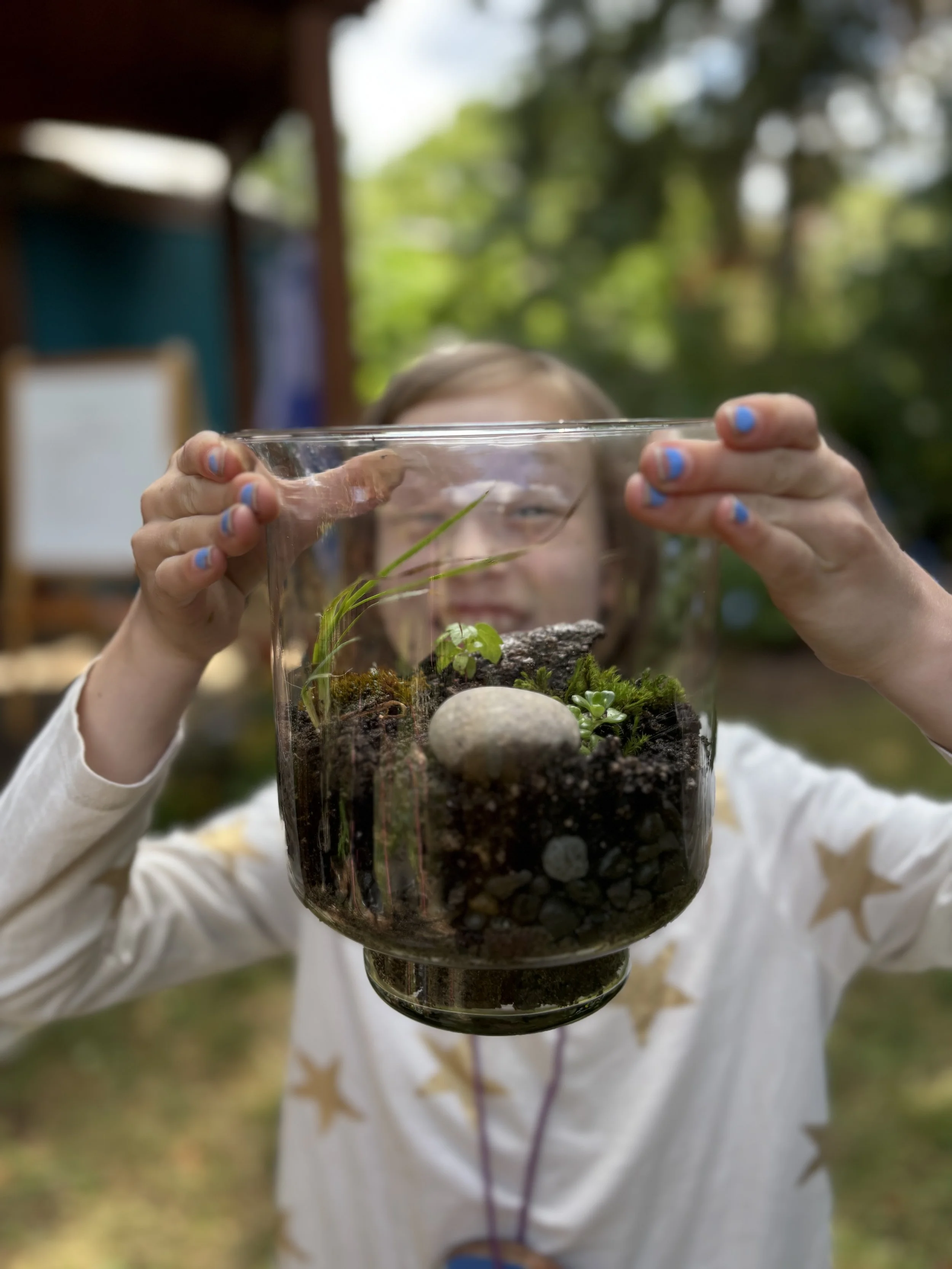 camp child holding terrarium.JPG