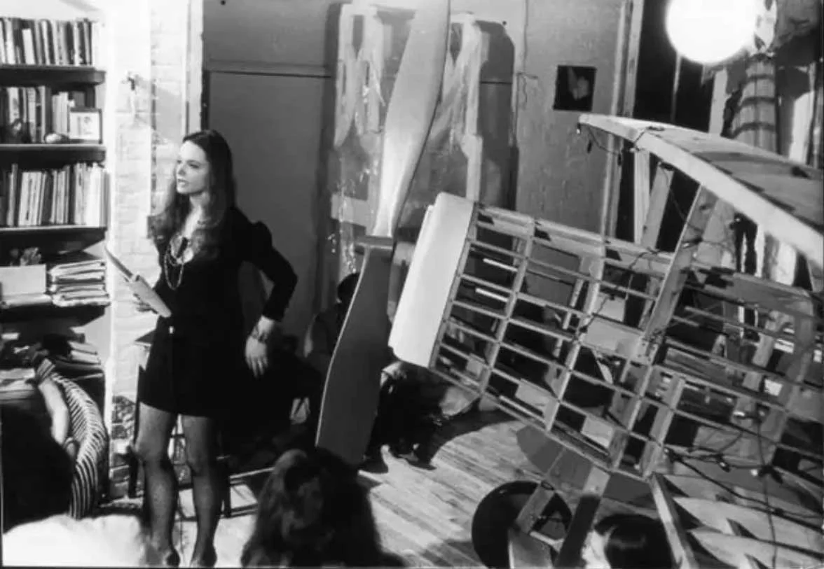 Anne Waldman gives a reading in a loft apartment belonging to artist Claes Oldenburg, New York, New York, May 24, 1968. The airframe of a small-scale single propeller aircraft (likely a sculpture) is at right. Photo by Fred W. McDarrah/The New York H