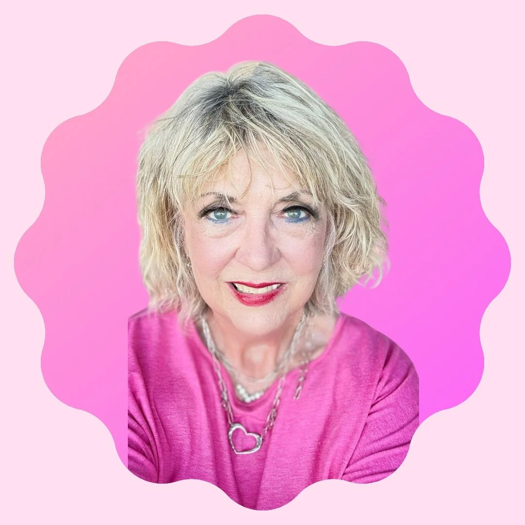 A smiling woman with blonde wavy hair wearing a light green shirt.