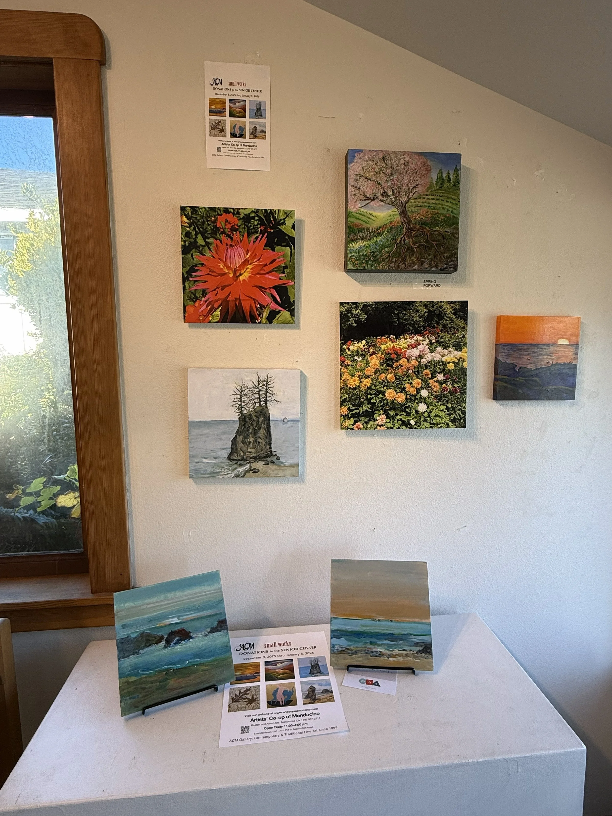 small works of art on a white gallery wall.