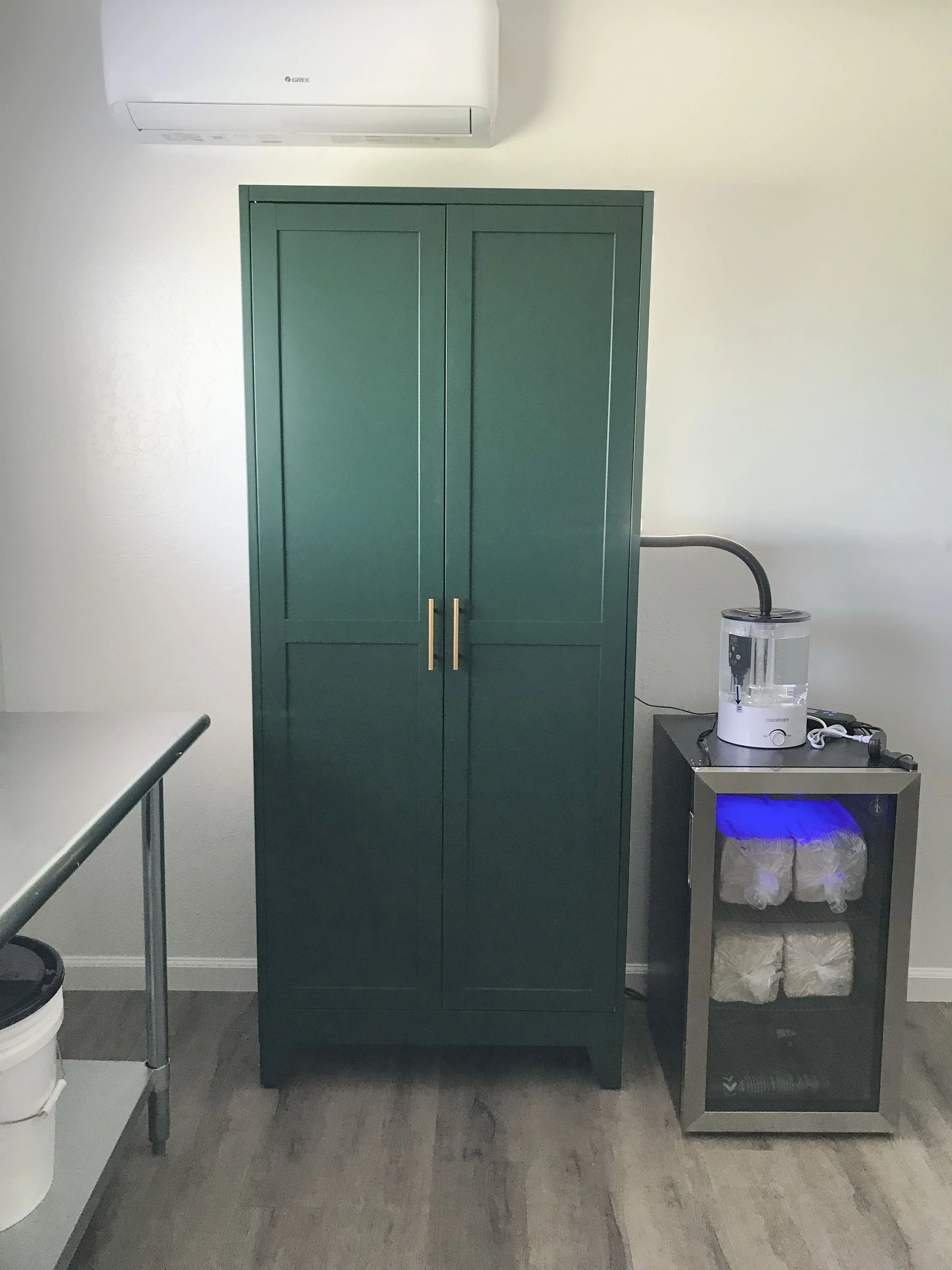 Tall steel cabinet with five adjustable shelves serve as the humidity change to dry porcelain pottery.