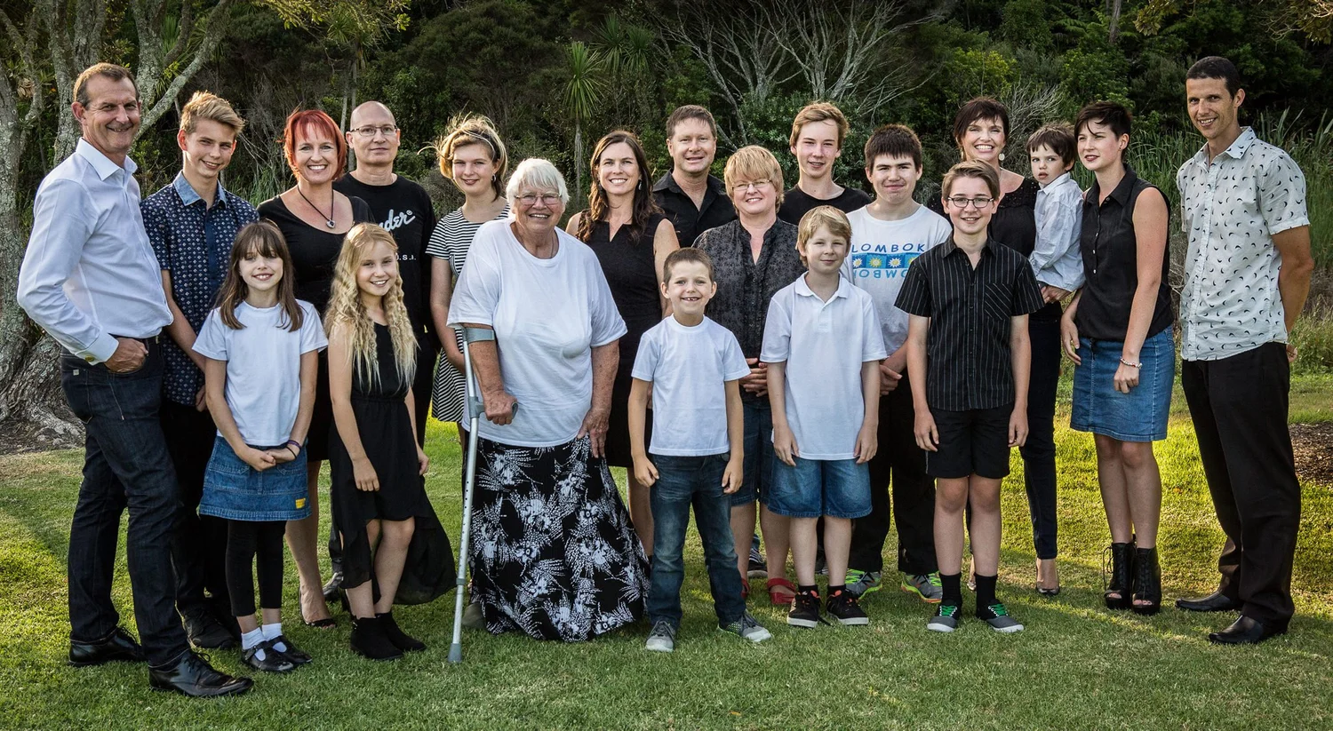 A large extended family gathered on a lawn