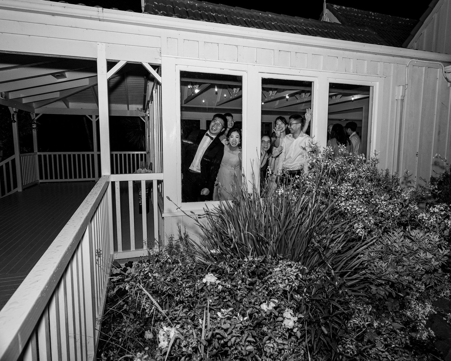 Black and white photo of guests on the veranda at night