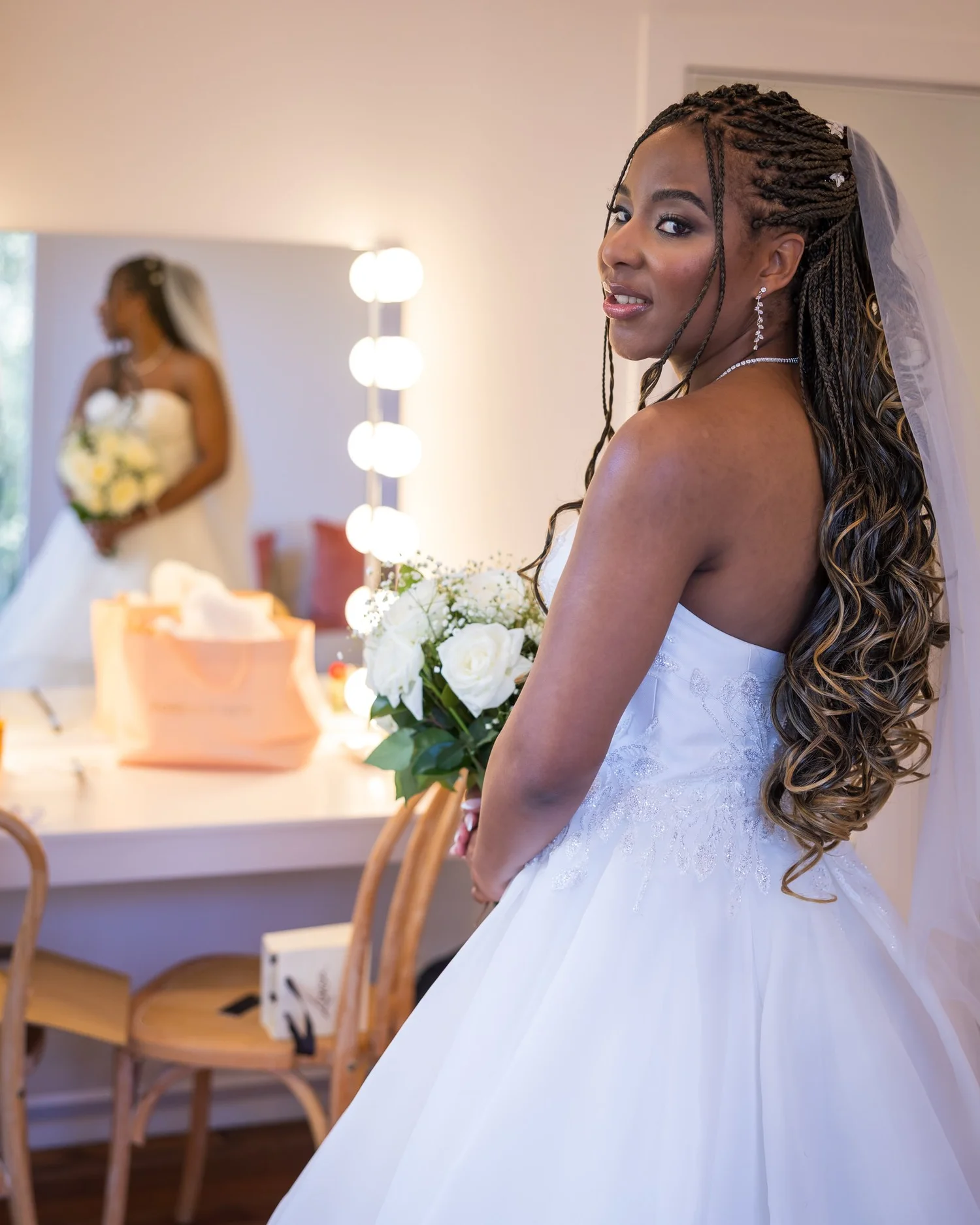 Chiedza looks over her shoulder in the bridal suite