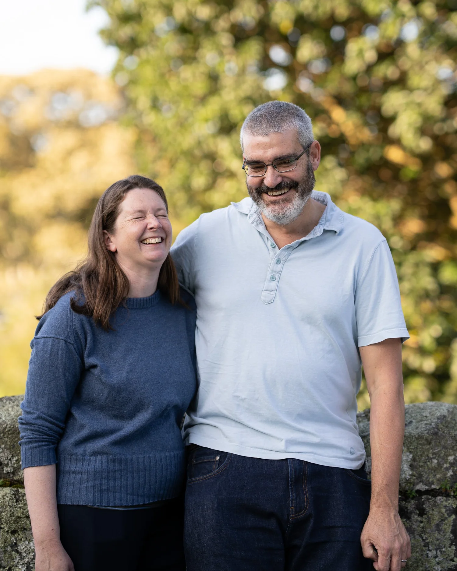The parents laugh together in the park