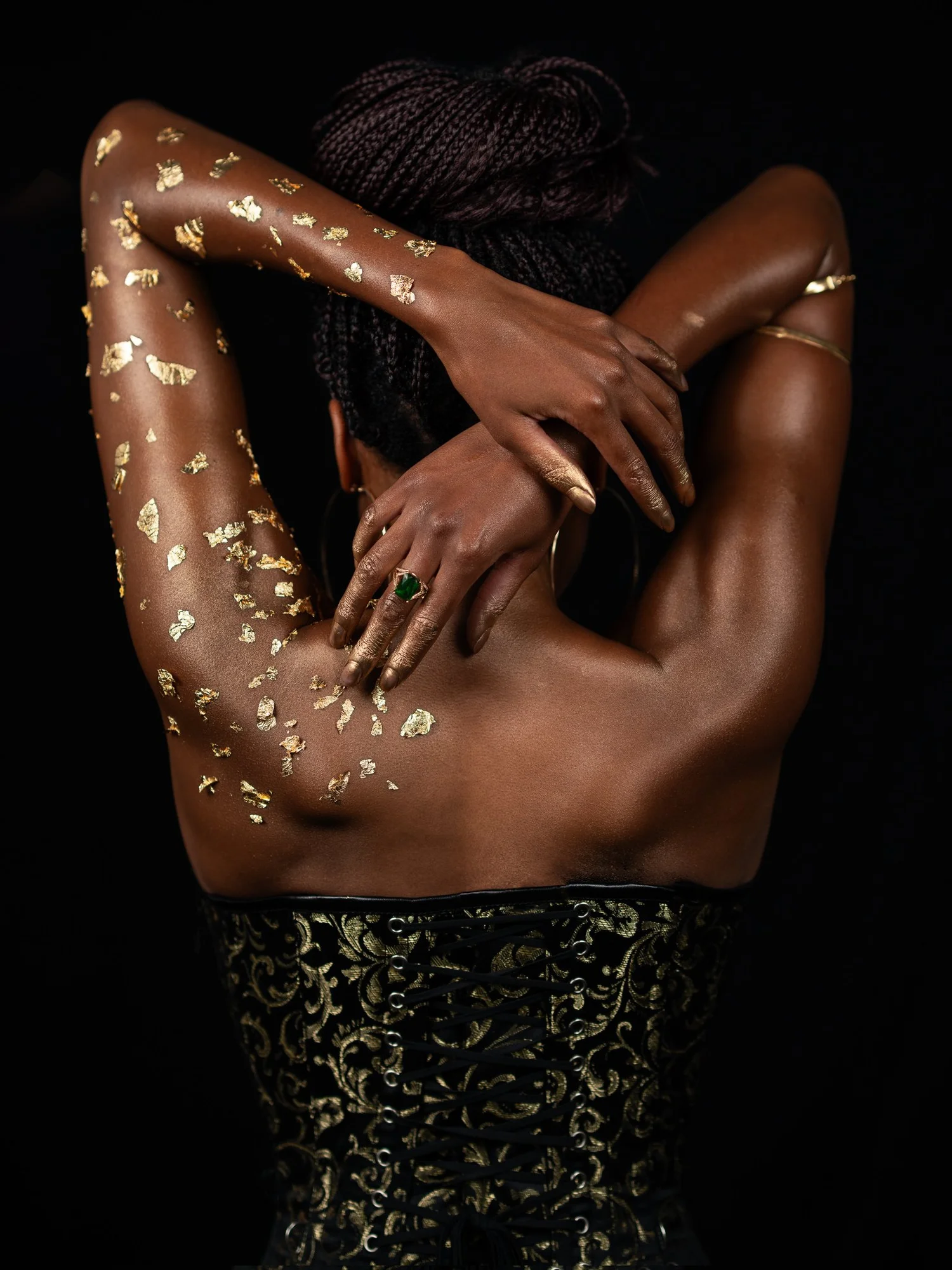 Ty's back and raised arms decorated with gold leaf