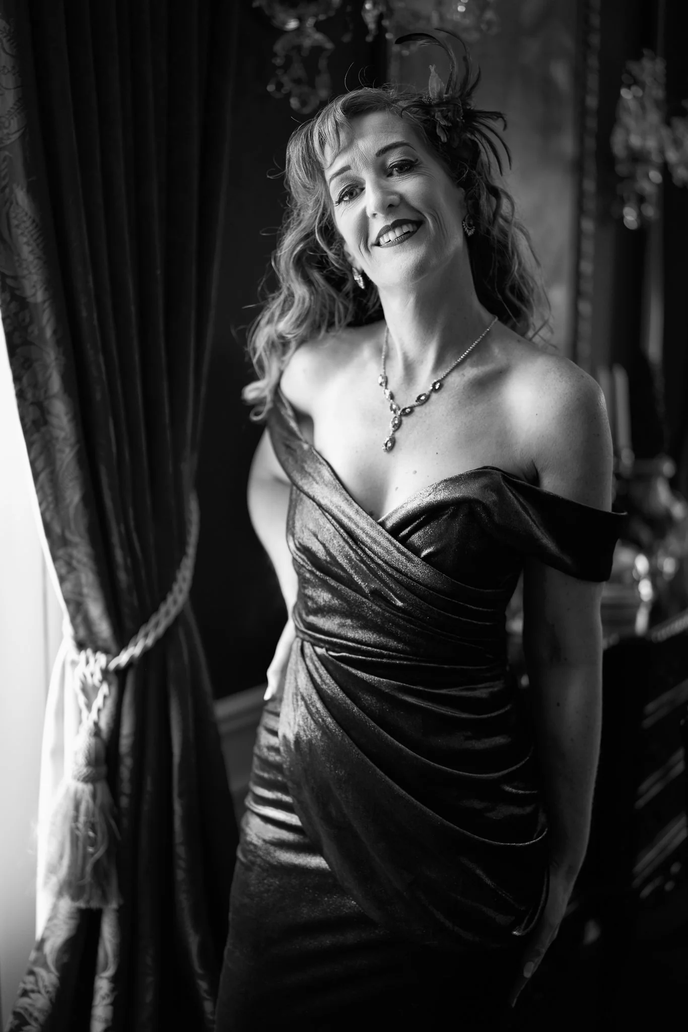Black and white photo of Sandy smiling in a satin gown