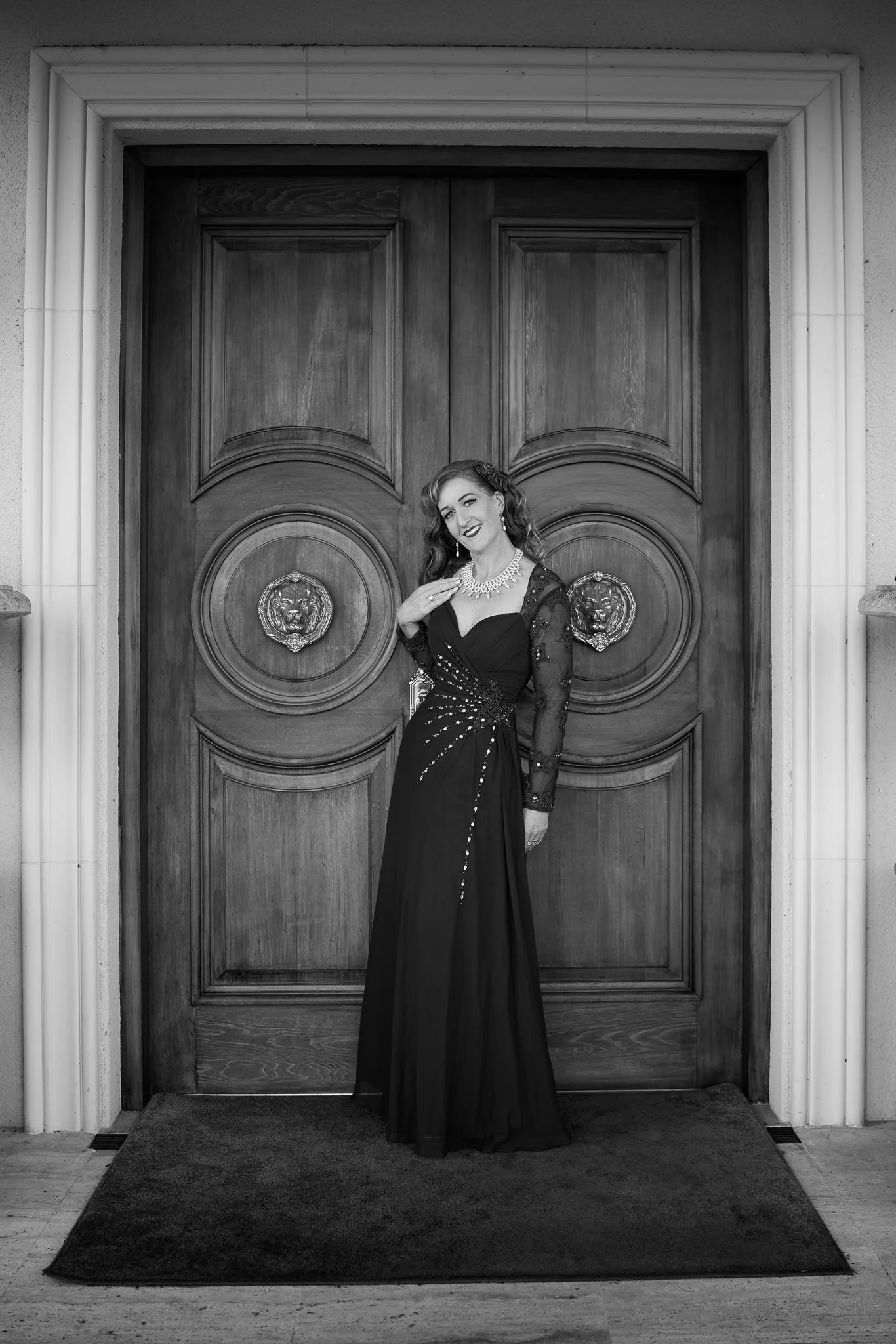 Black and white photo of Sandy before grand wooden doors