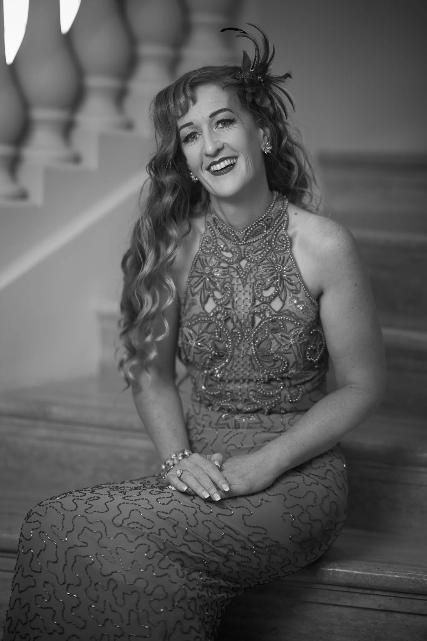 Black and white photo of Sandy seated on the stairs