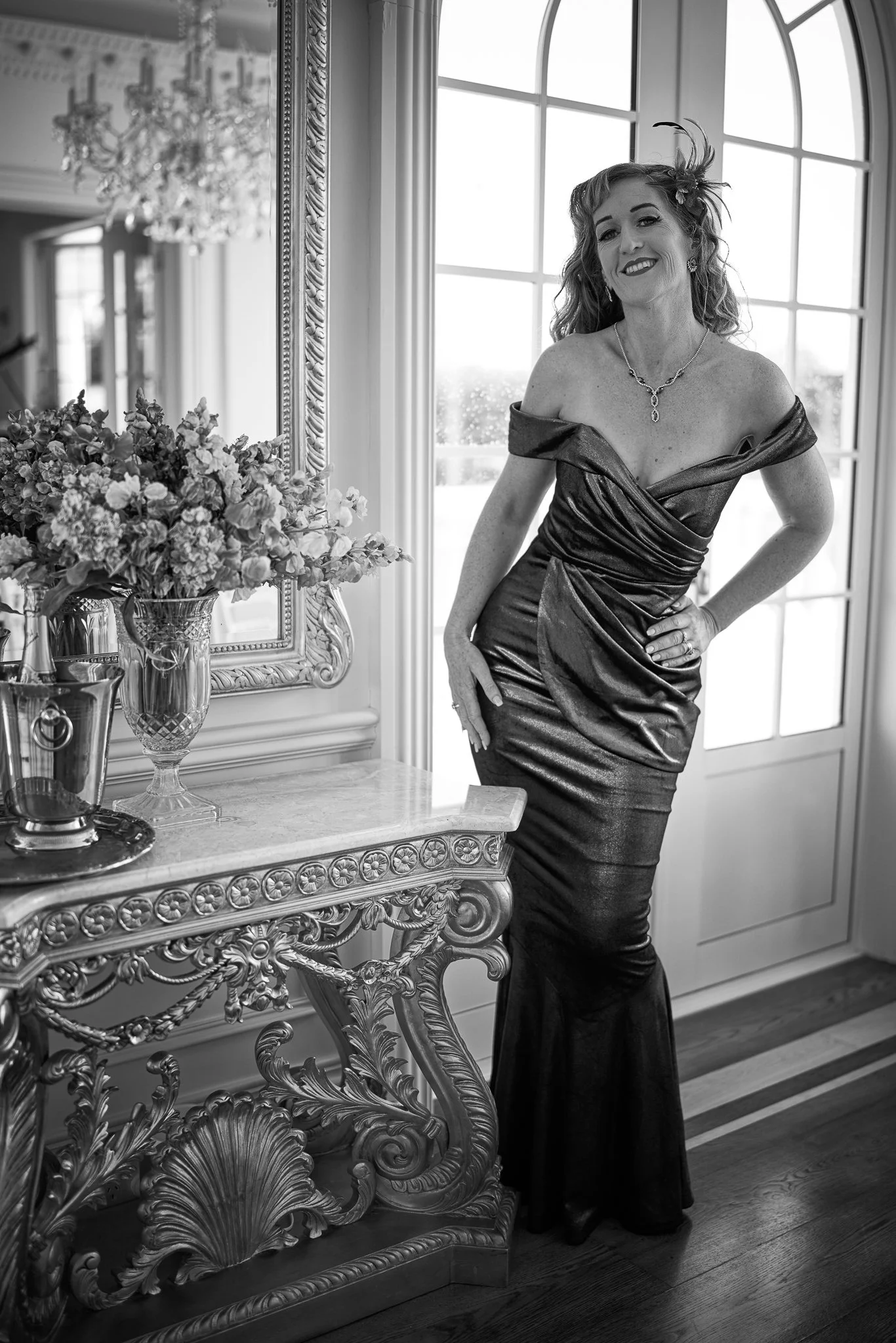 Black and white photo of Sandy beside a gilded console