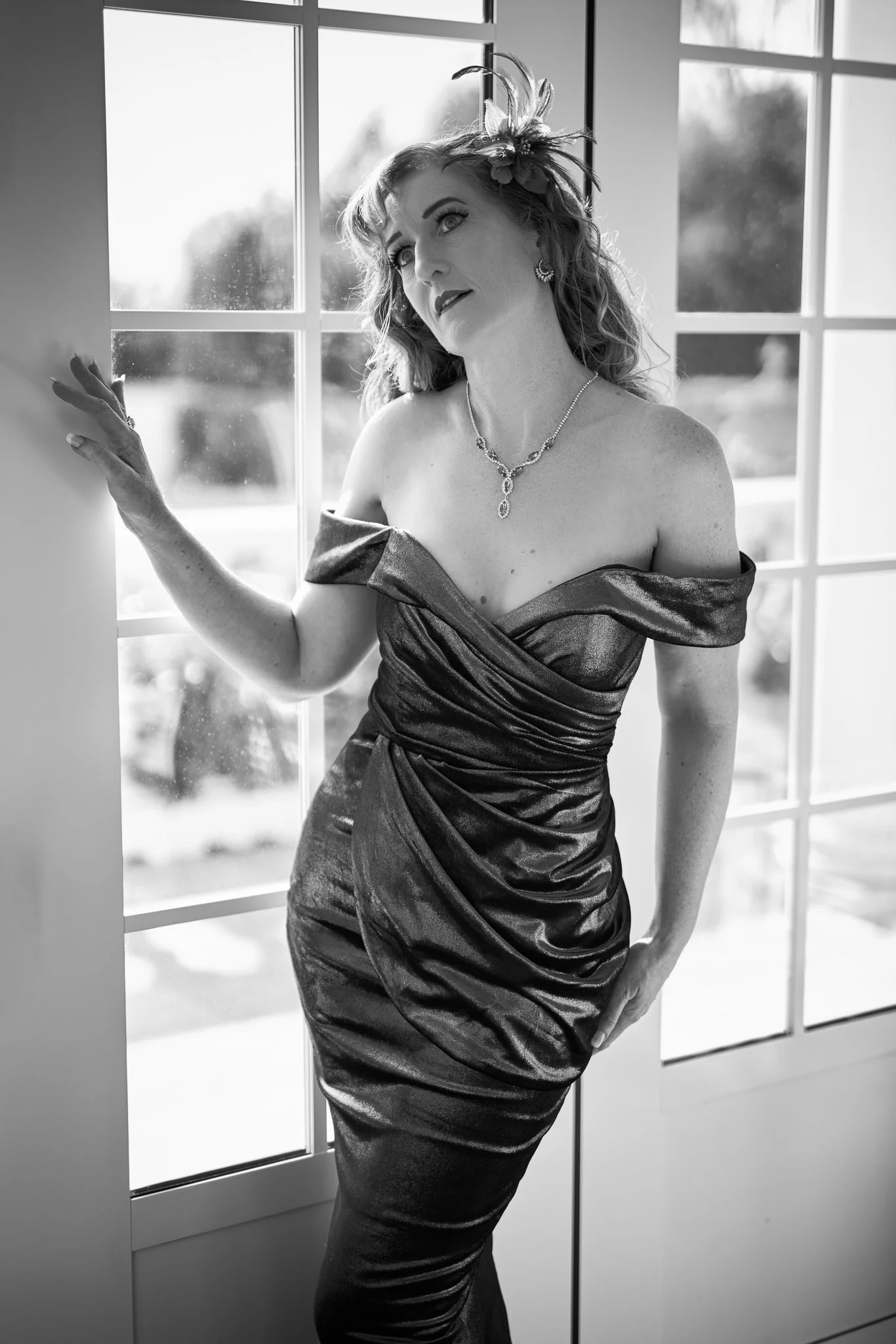 Black and white photo of Sandy by French doors