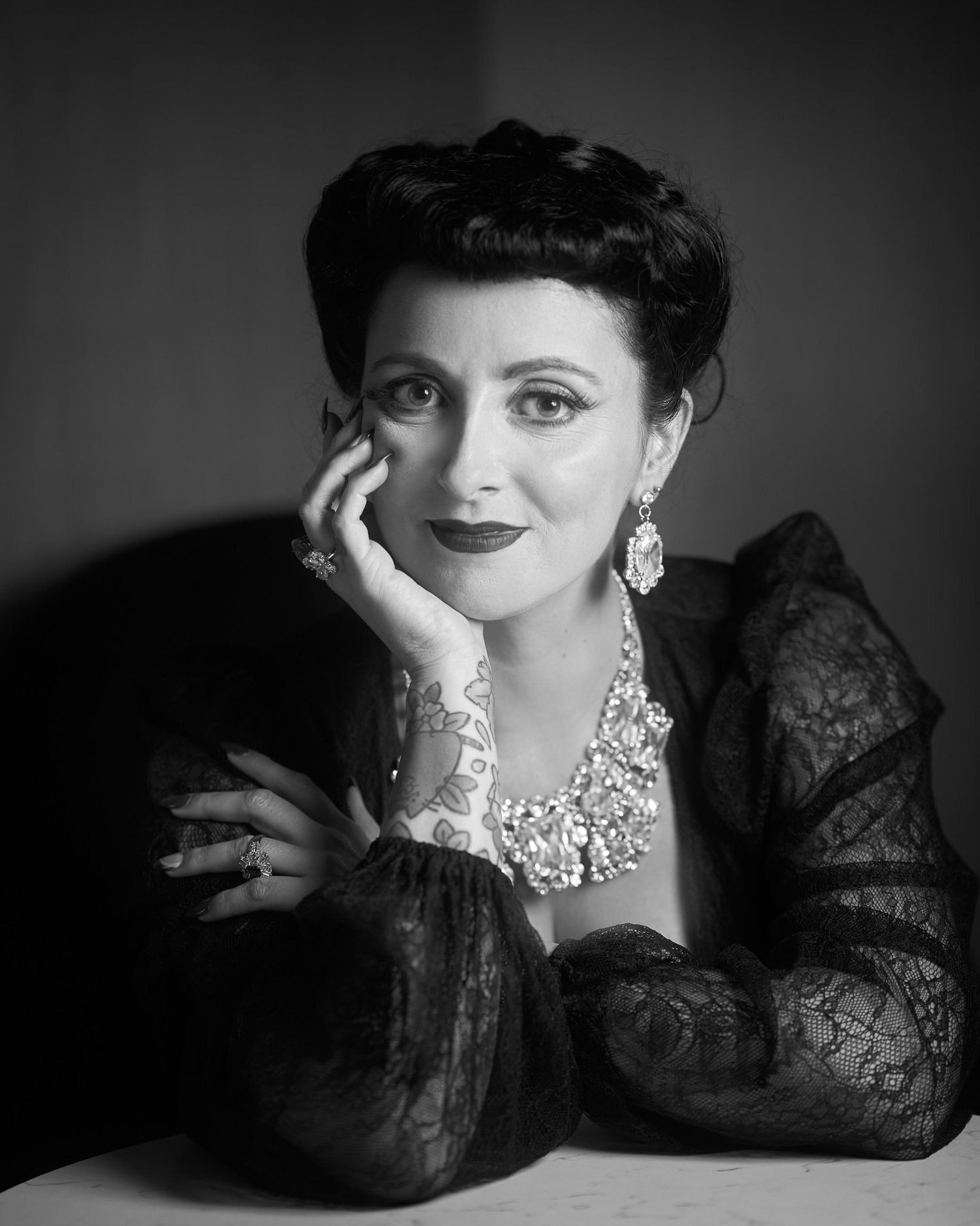 Black and white portrait of Viv in lace and jewels