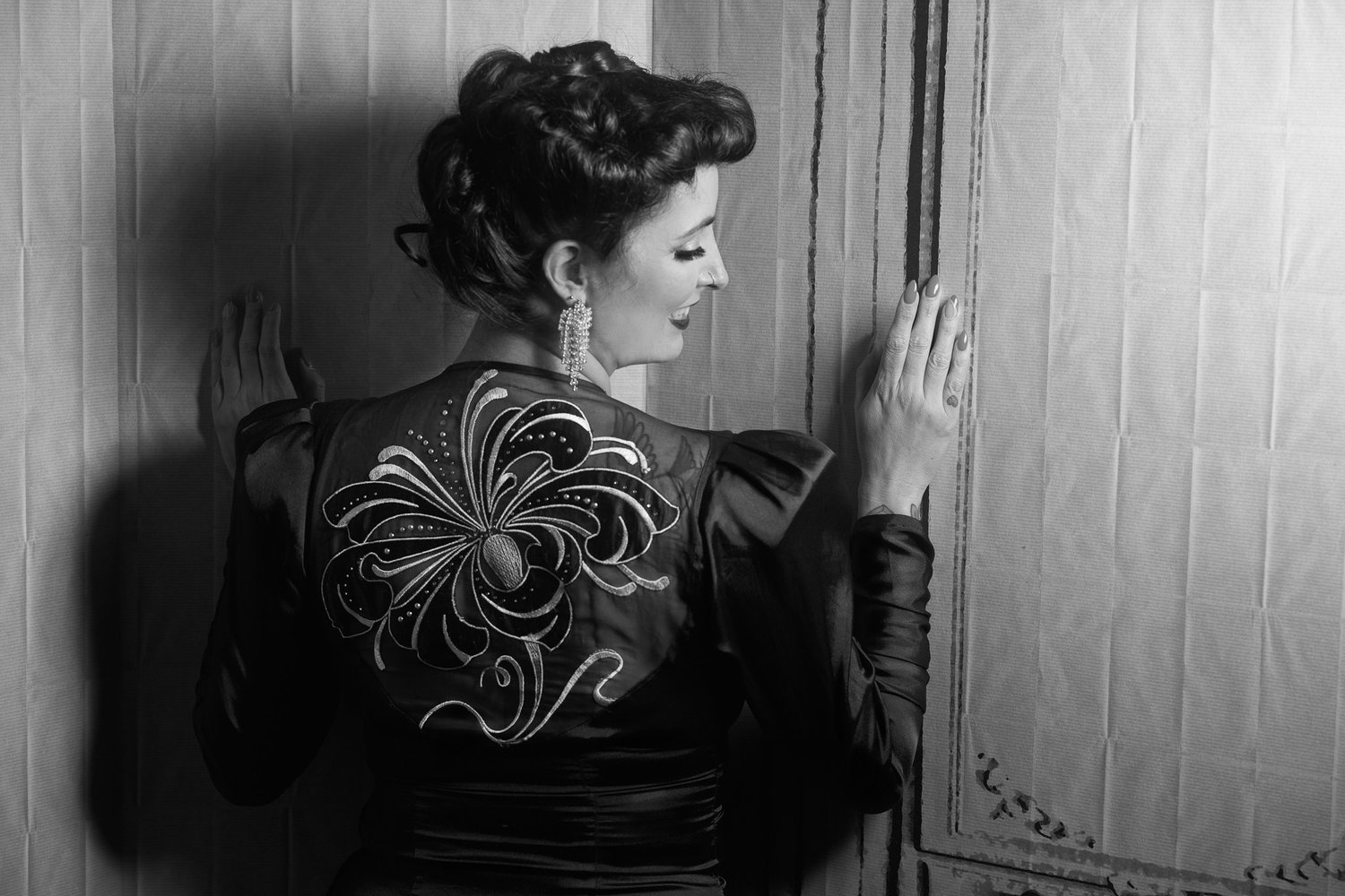 Black and white photo of Viv from behind showing an embroidered back