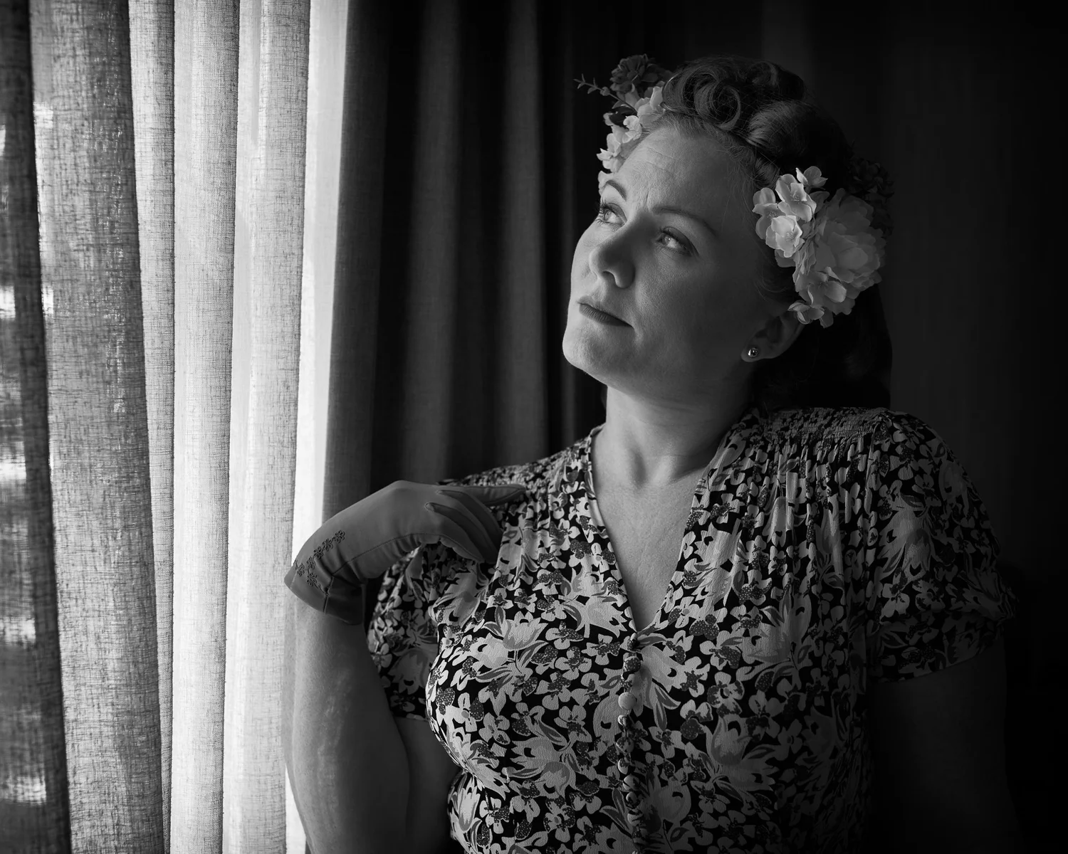 Black and white photo of Laura with flowers in her hair