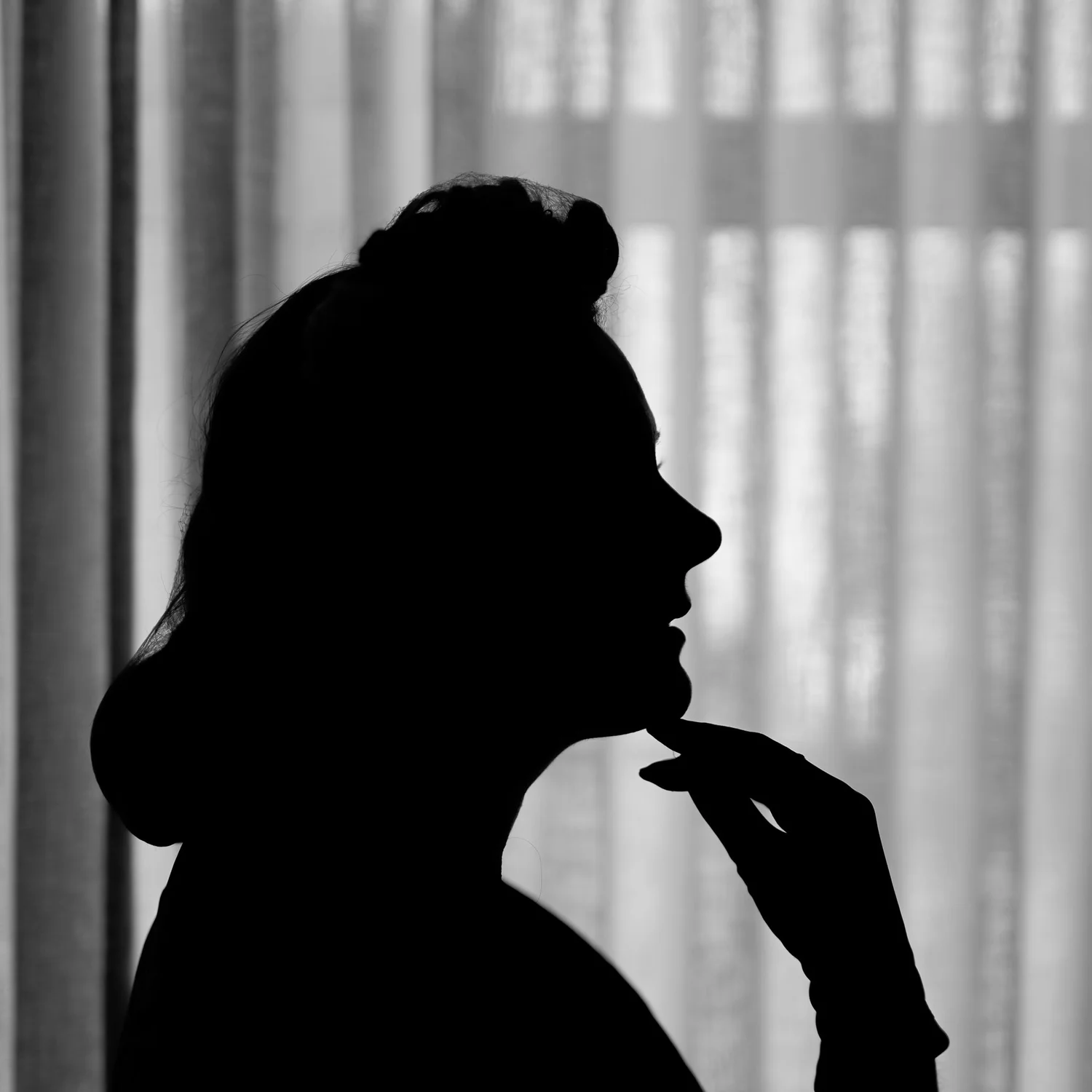 Silhouette of Laura in profile against a bright window