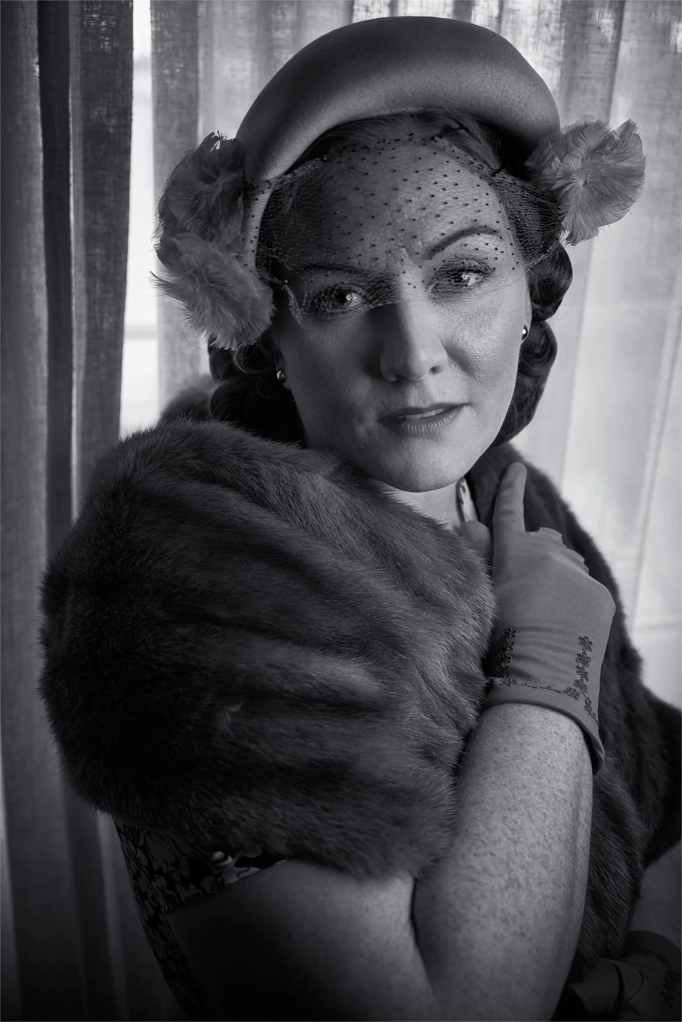 Black and white photo of Laura in a hat and fur stole