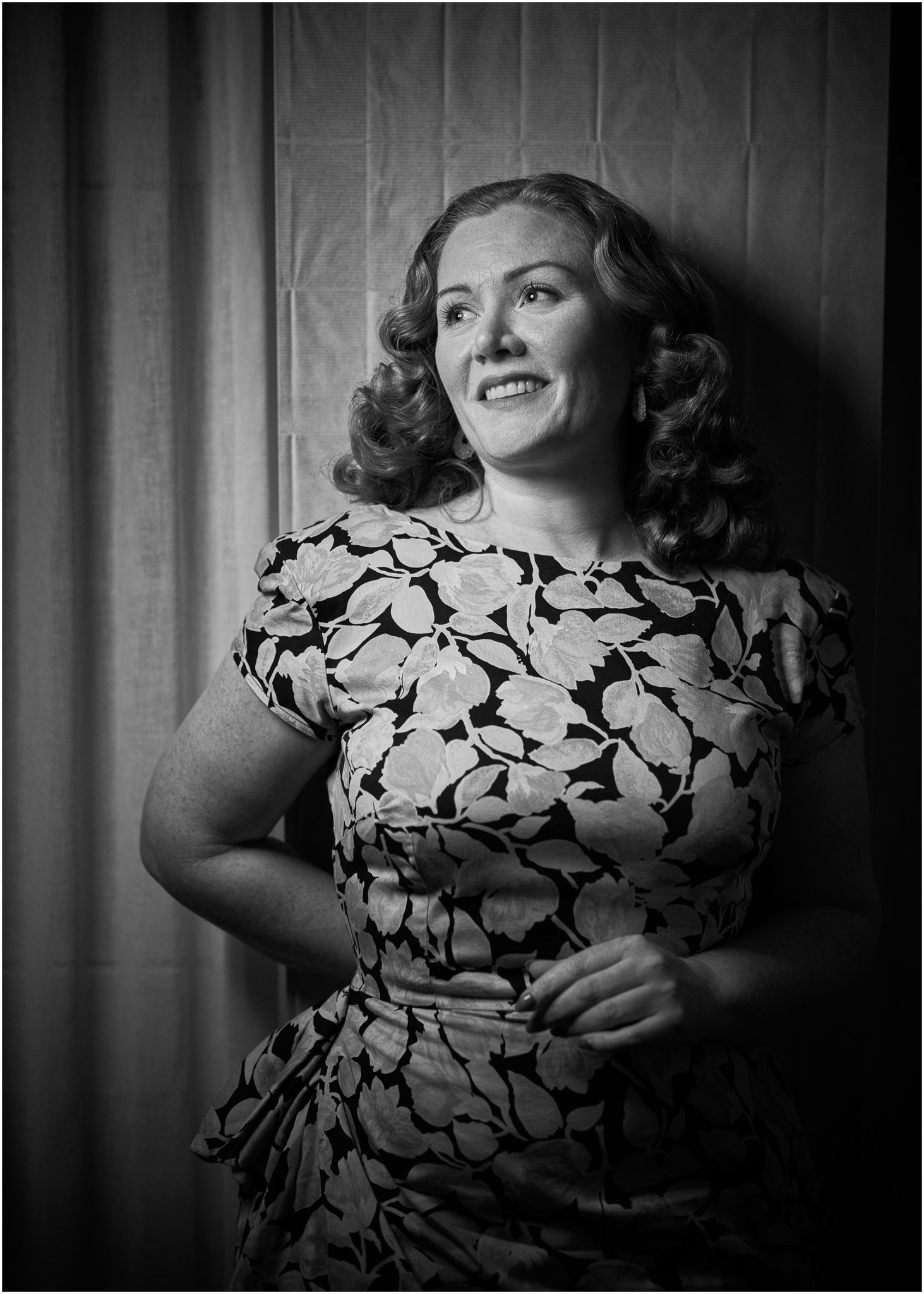 Black and white photo of Laura in a floral dress