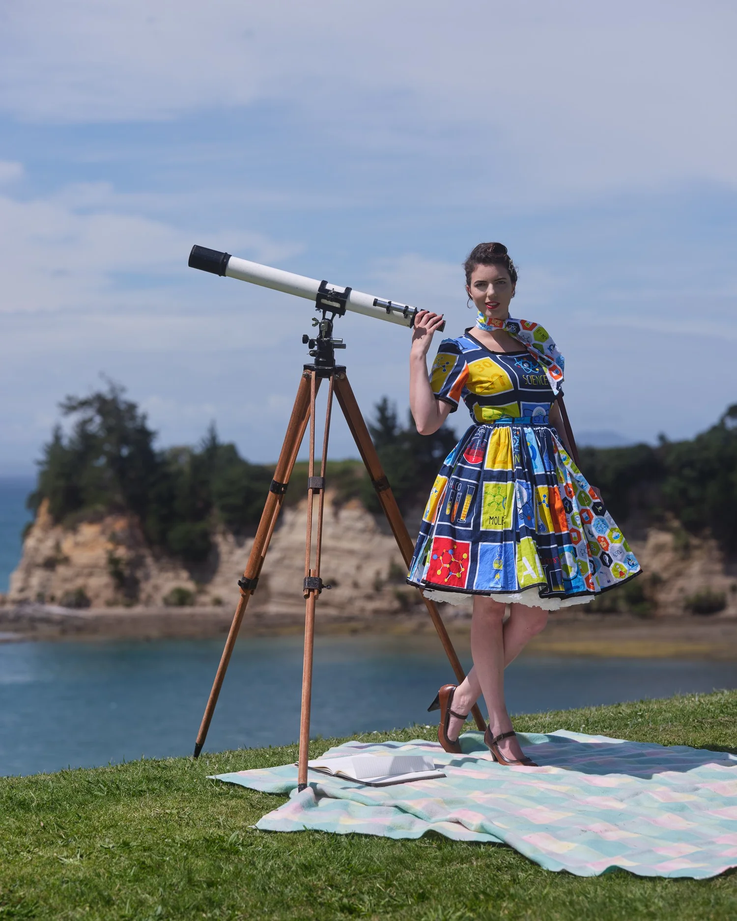 Jay smiles beside the telescope on the cliff