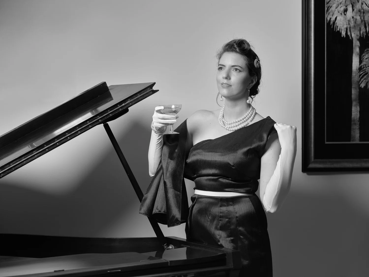 Black and white photo of Jay with a cocktail glass