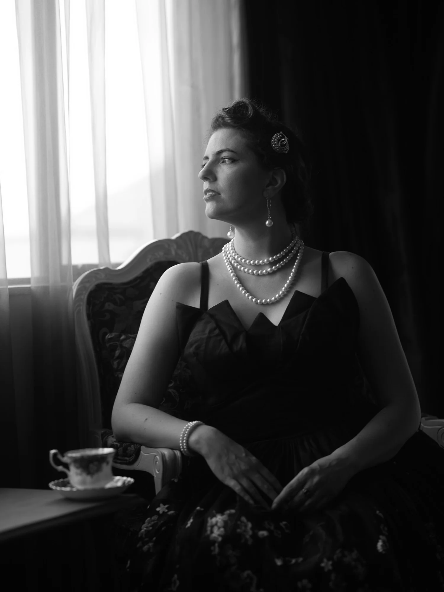 Black and white photo of Jay seated by the window