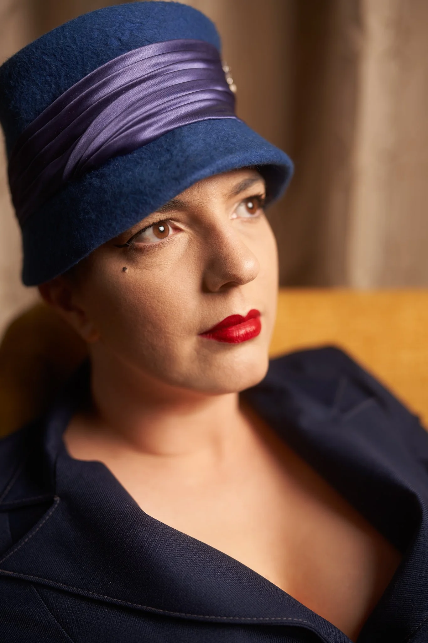 Close portrait of Jay in a blue cloche hat