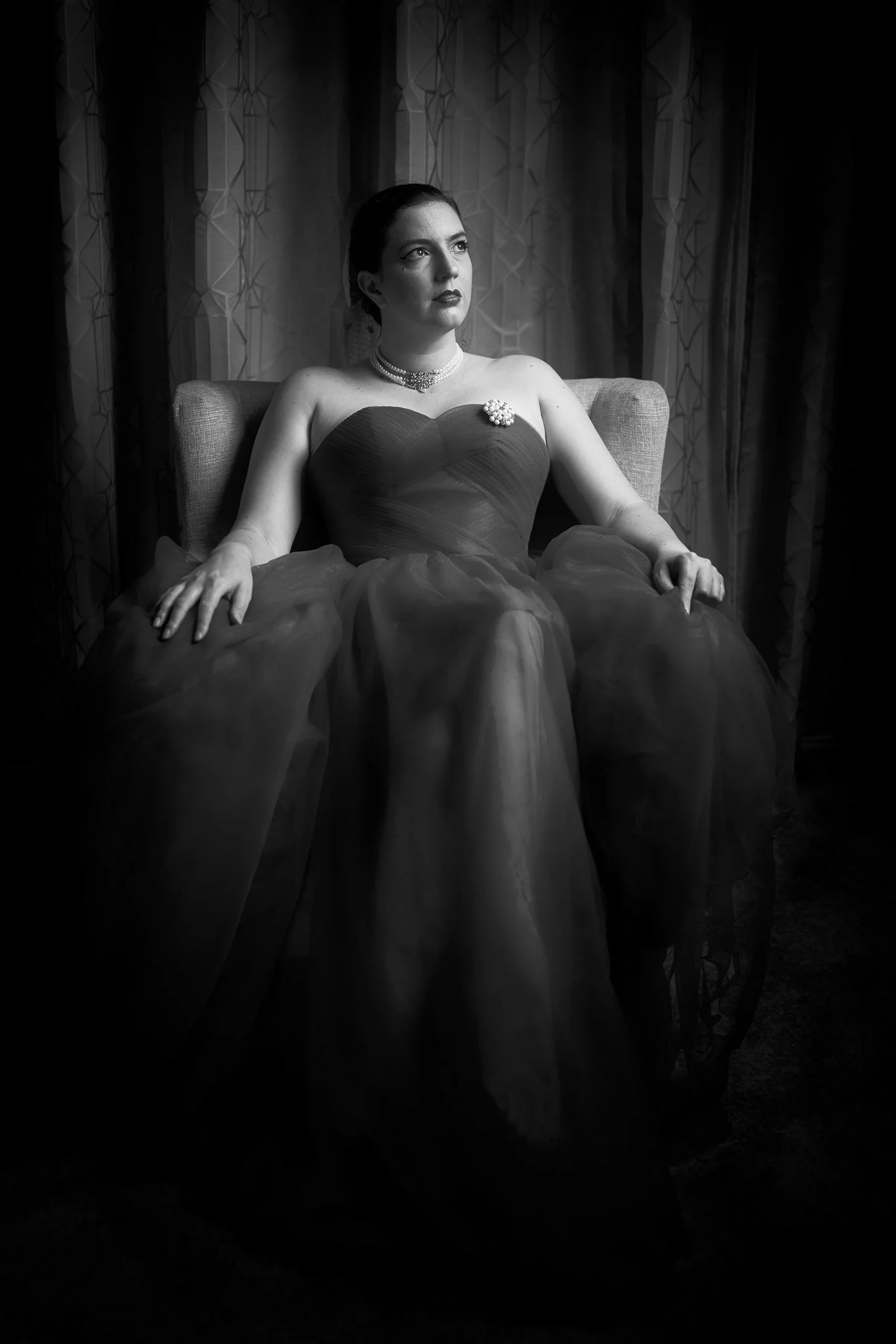 Black and white photo of Jay seated in a full gown