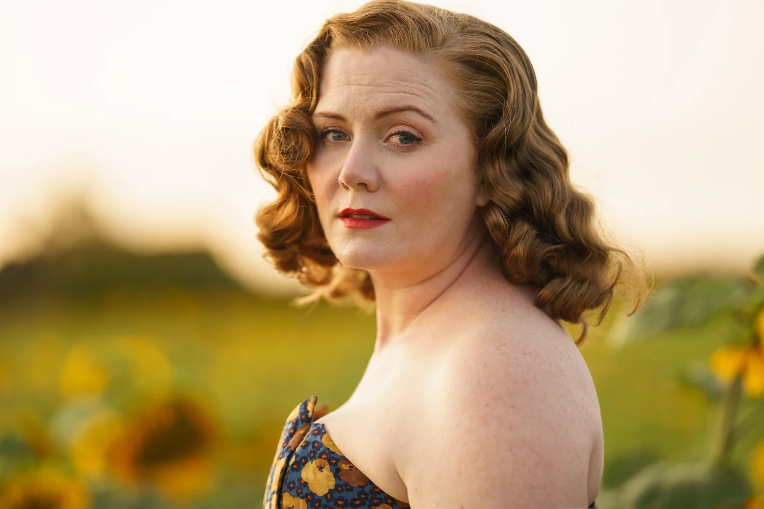 A model with vintage curls among the sunflowers at sunset in Franklin