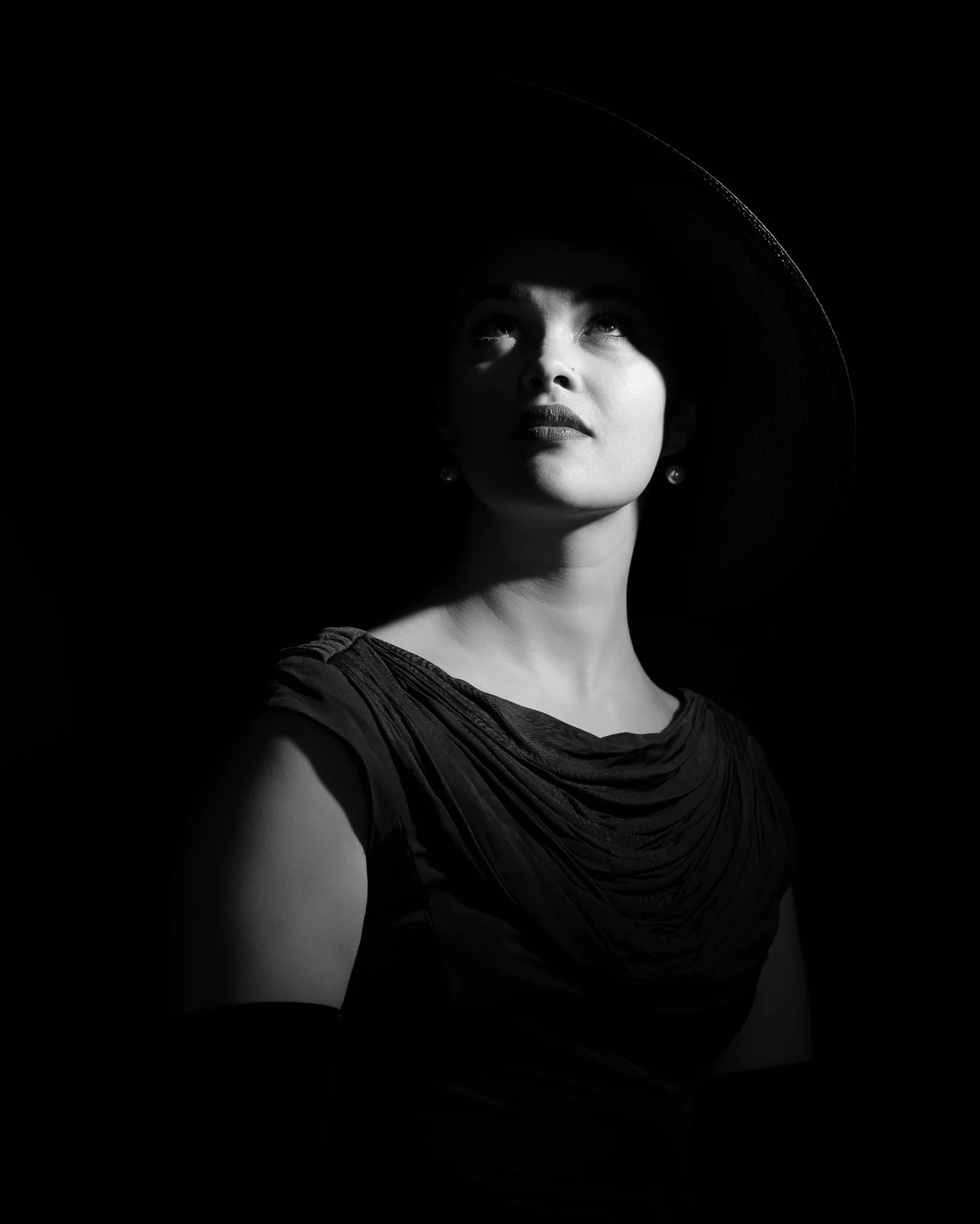 Black and white portrait of Anita lit against a dark background
