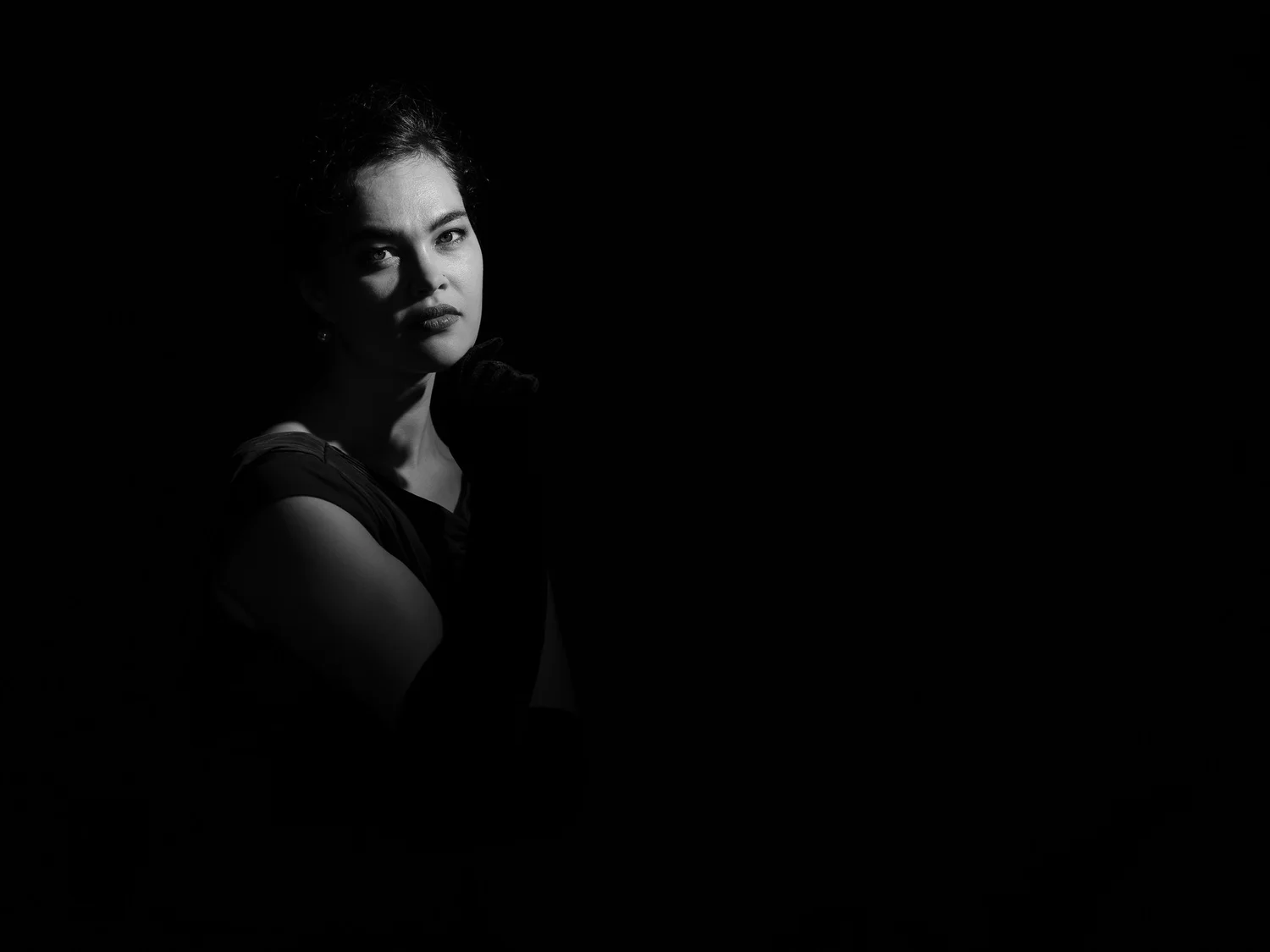 Anita's face emerging from deep shadow in a low-key portrait