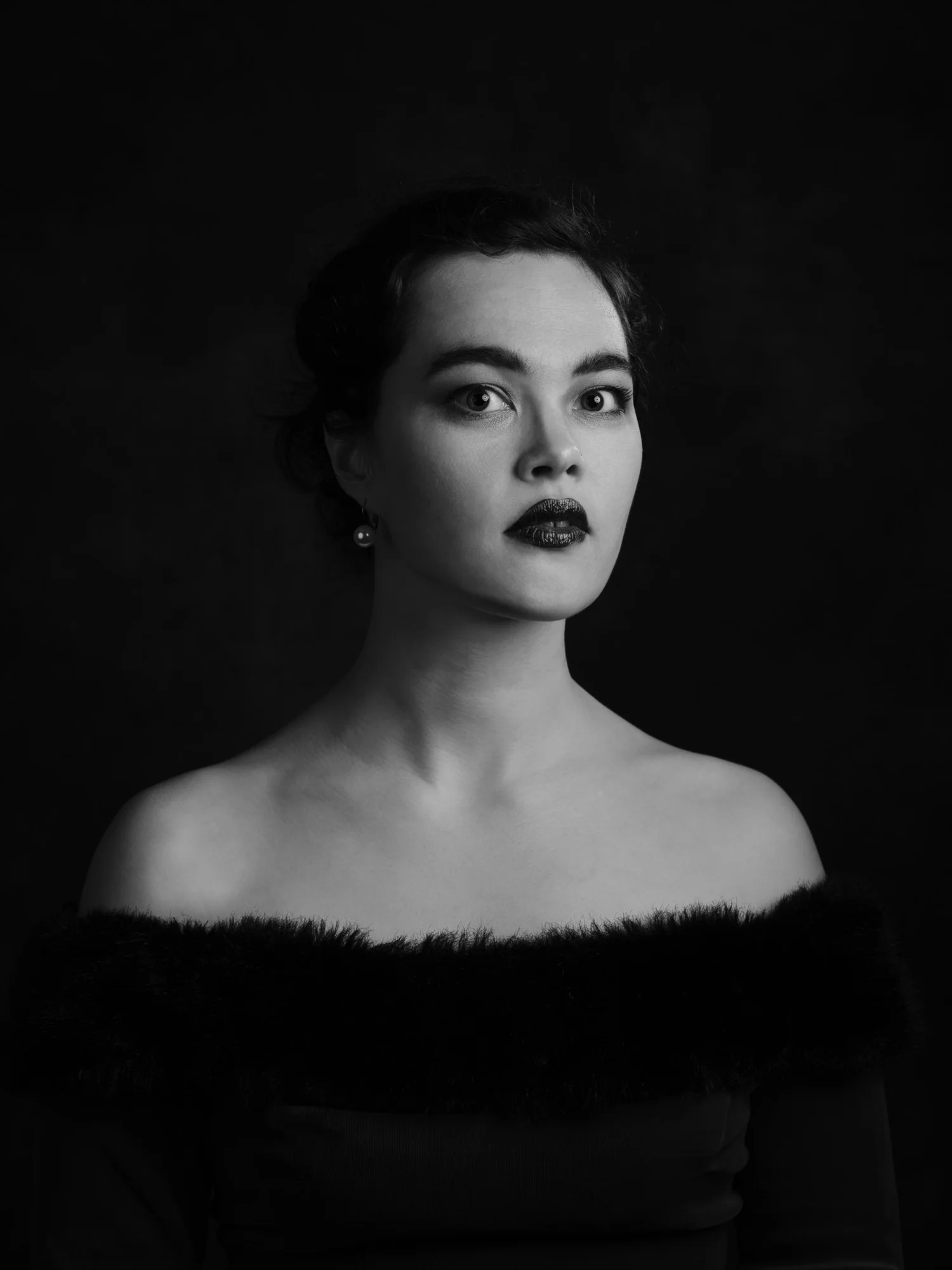 Black and white portrait of Anita with dark lipstick and bare shoulders