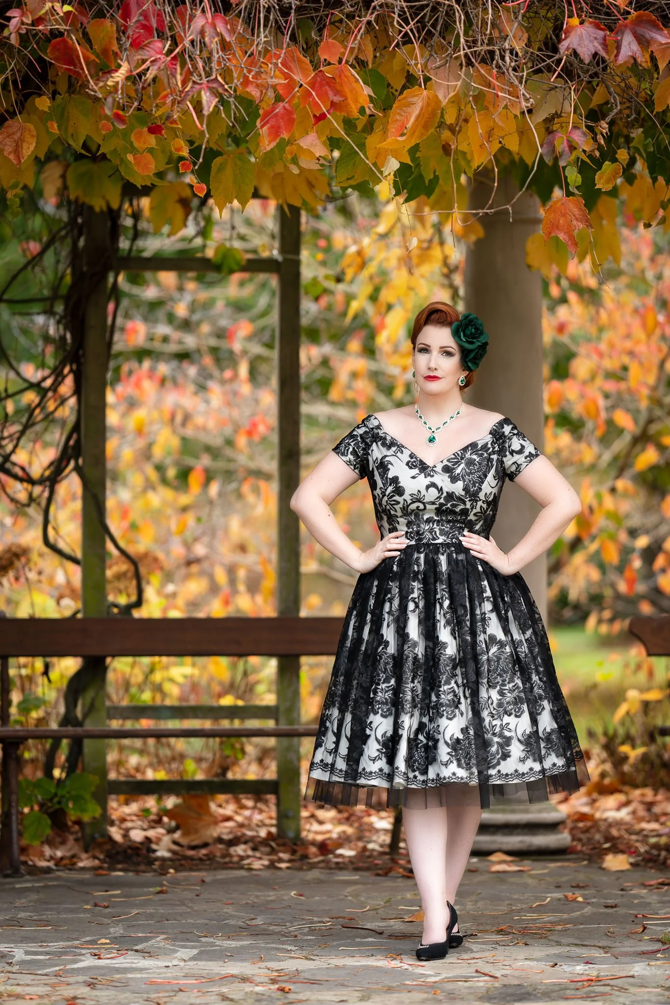 Jasmine stands beneath autumn vines in a vintage lace dress