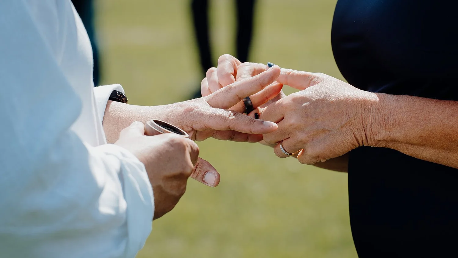 Close-up of Raewyn and Shane exchanging rings