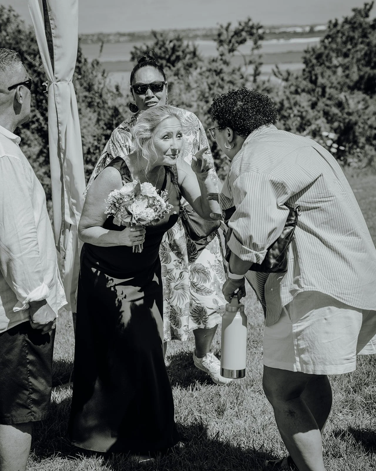 Black and white photo of a guest hugging Raewyn