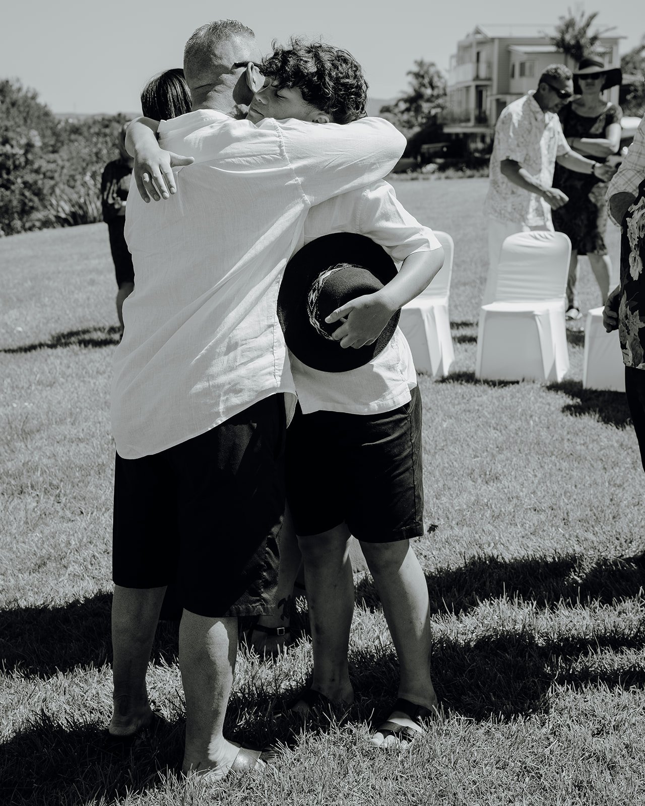 Black and white photo of Shane hugging a guest
