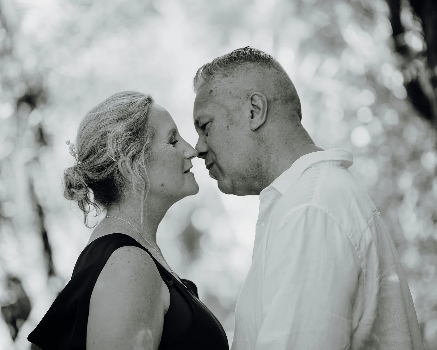 Black and white photo of Raewyn and Shane nose to nose
