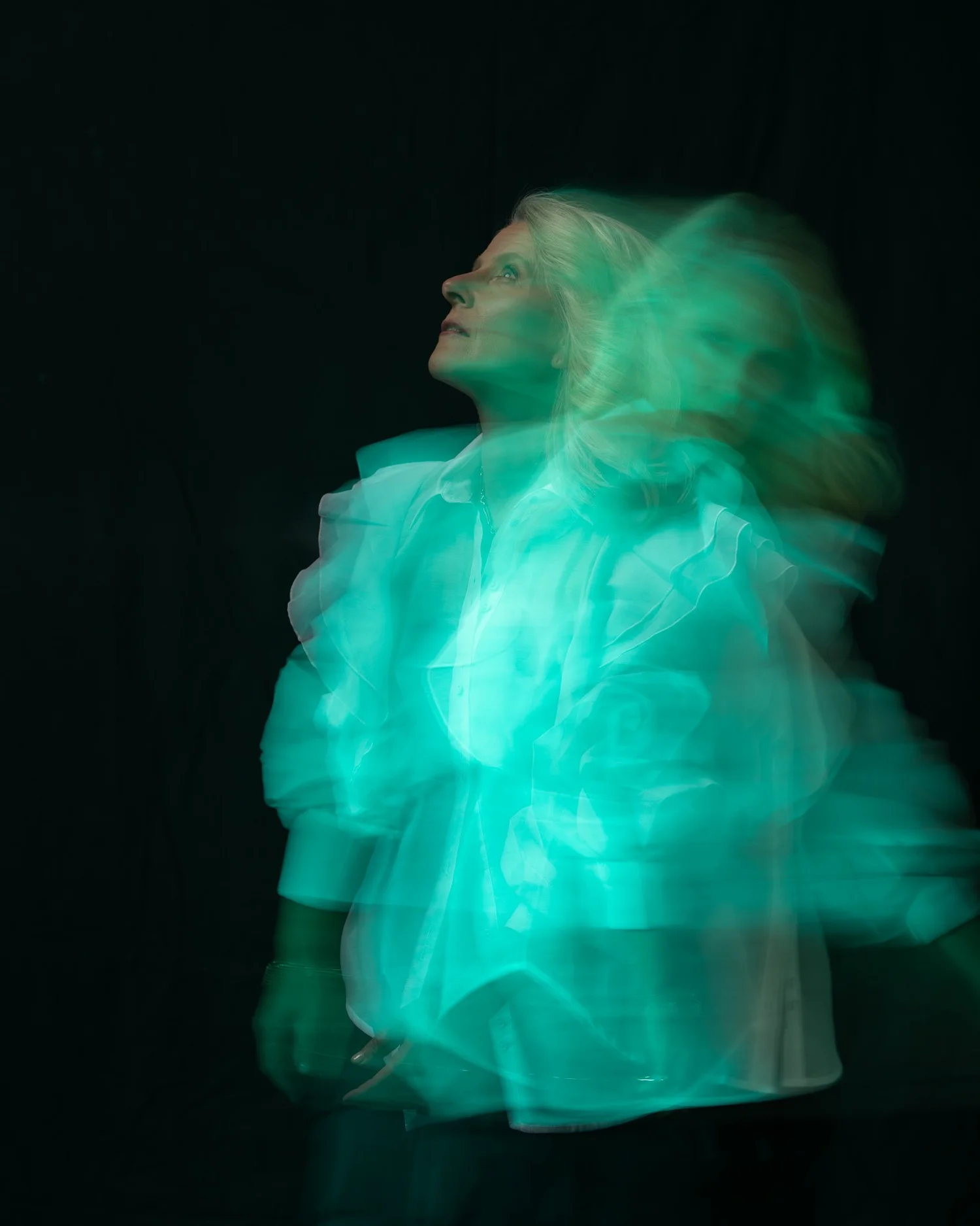 Creative motion-blur portrait of Ivanka glowing green