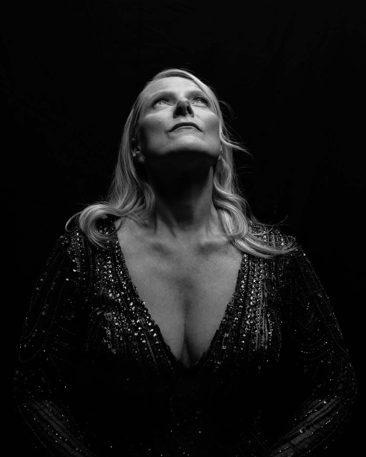 Black and white photo of Ivanka looking upwards in a sequinned gown