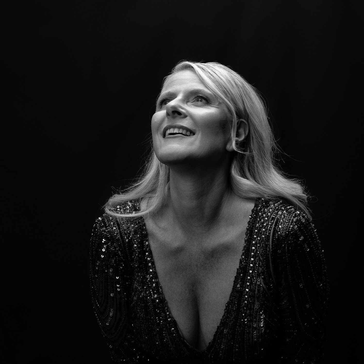 Black and white photo of Ivanka smiling upwards