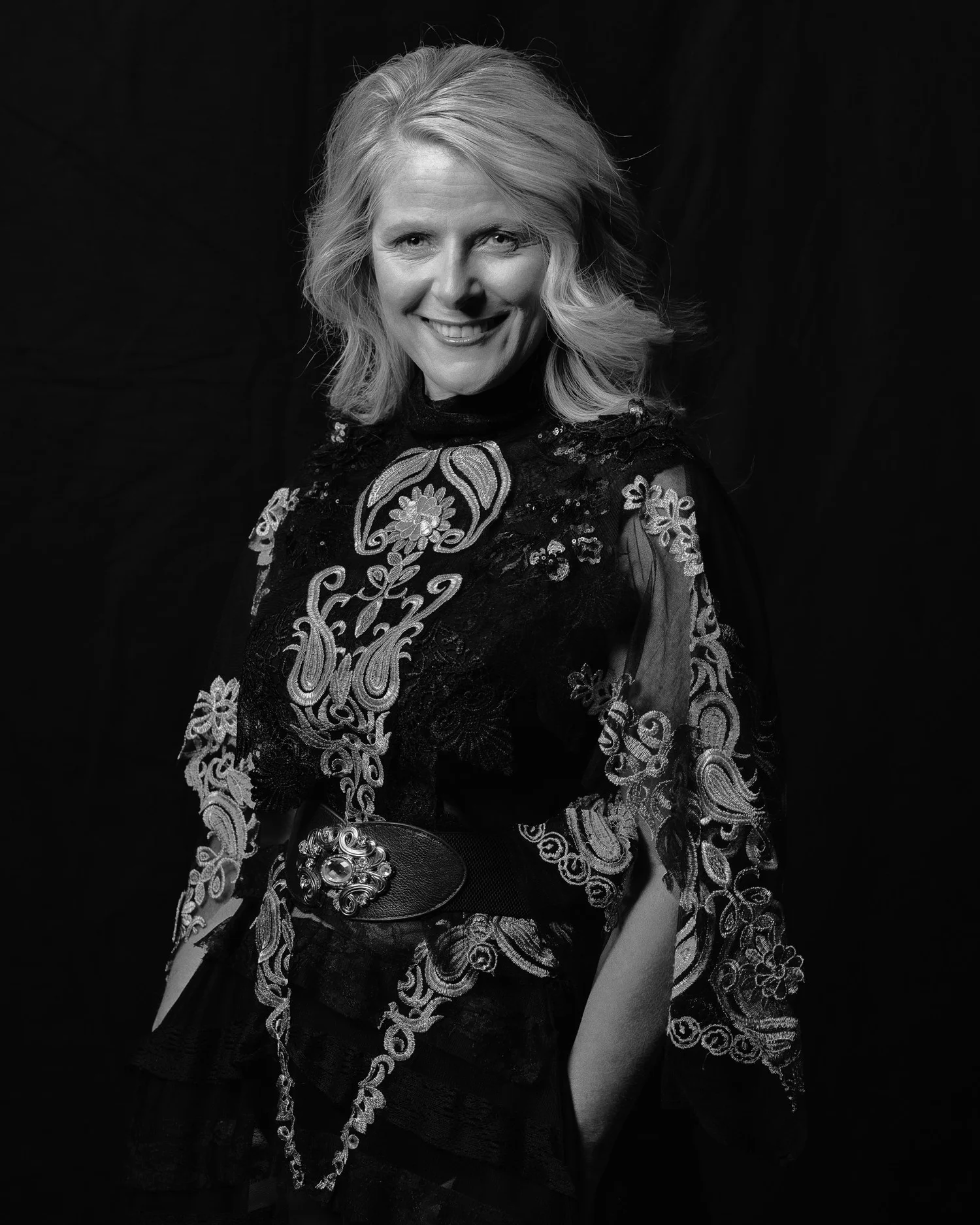 Black and white photo of Ivanka smiling in an embroidered gown